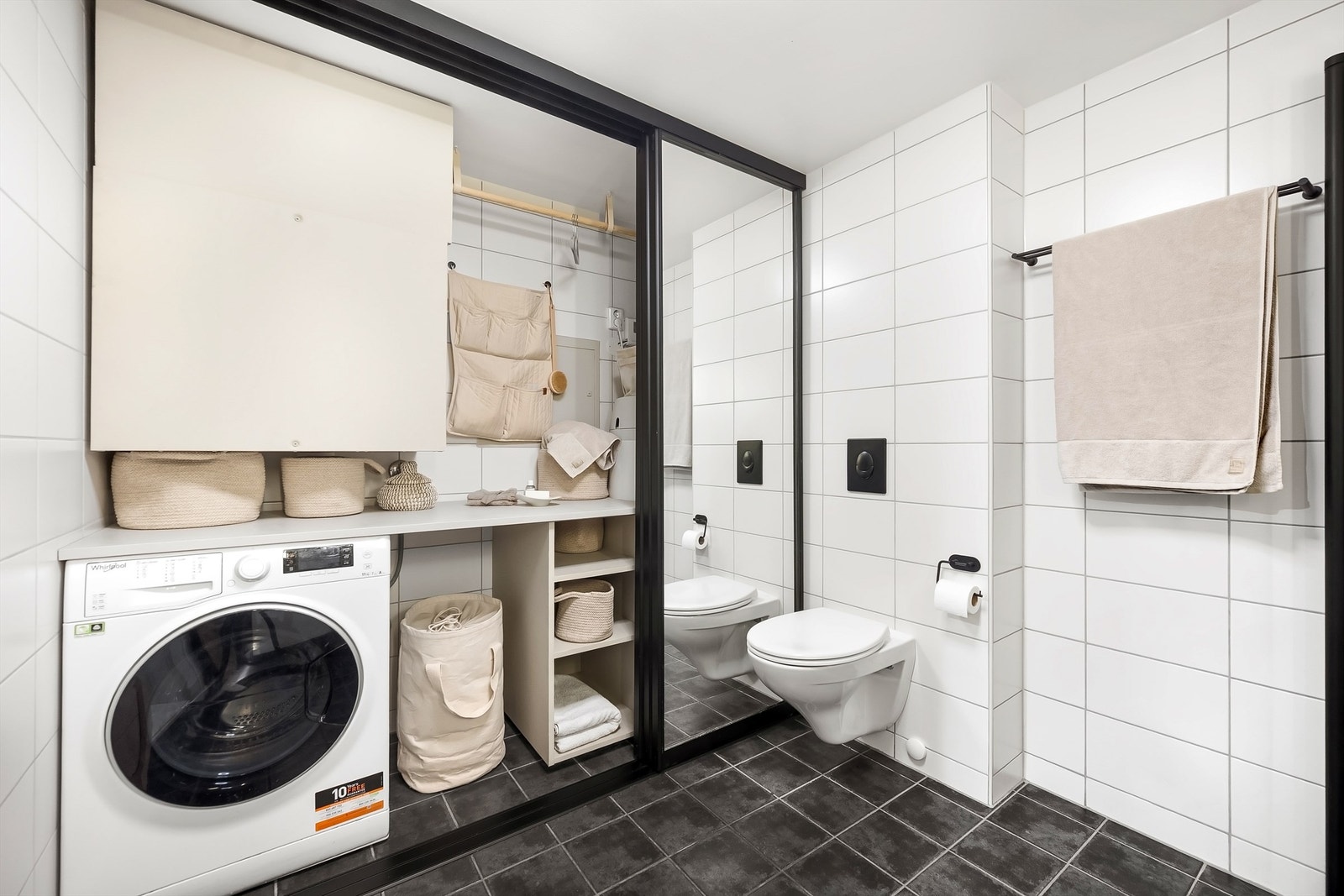 Bak skyvedørene på badet skjuler det seg en smart og arealeffektiv vaskeromsløsning. Galleribilde