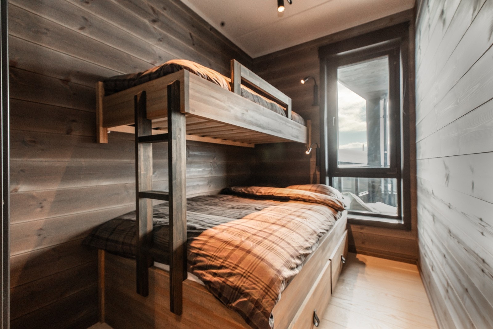 Det ene er innredet med familiekøye som har skuffer i sokkel Galleribilde