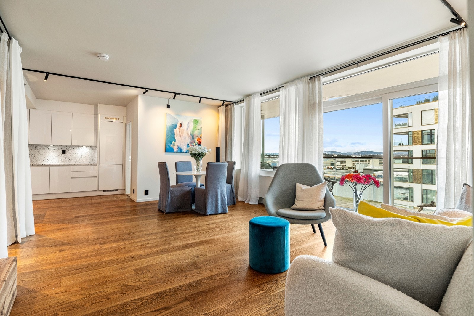 Store vinduflater gir godt med naturlig lys til rommet, og byr på nydelig fjordutsikt fra sofakroken Galleribilde