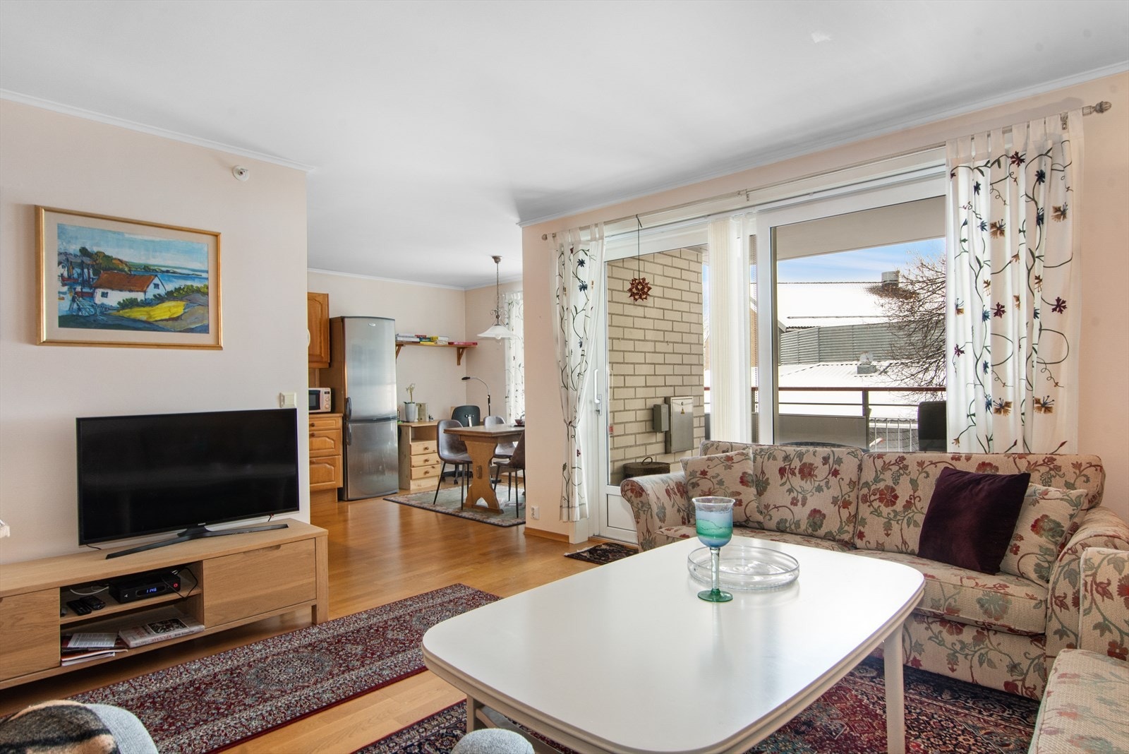 Fra stuen er det åpen løsning mot kjøkkenet. Fint å få litt gjennomgående naturlig lys inn i en liten leilighet! Galleribilde