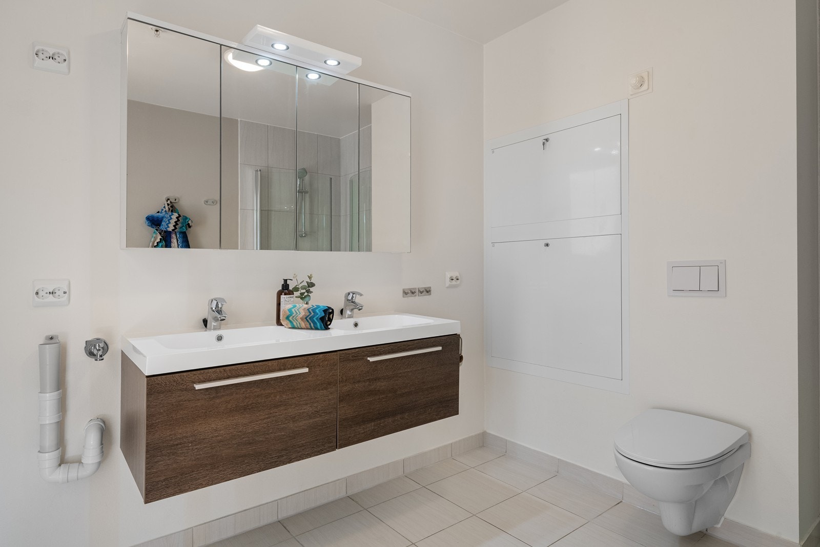 Badet er innredet med dobbel servant og nedfelt kum over skuffeseksjon. Vegghengt WC og varme i gulv. Galleribilde