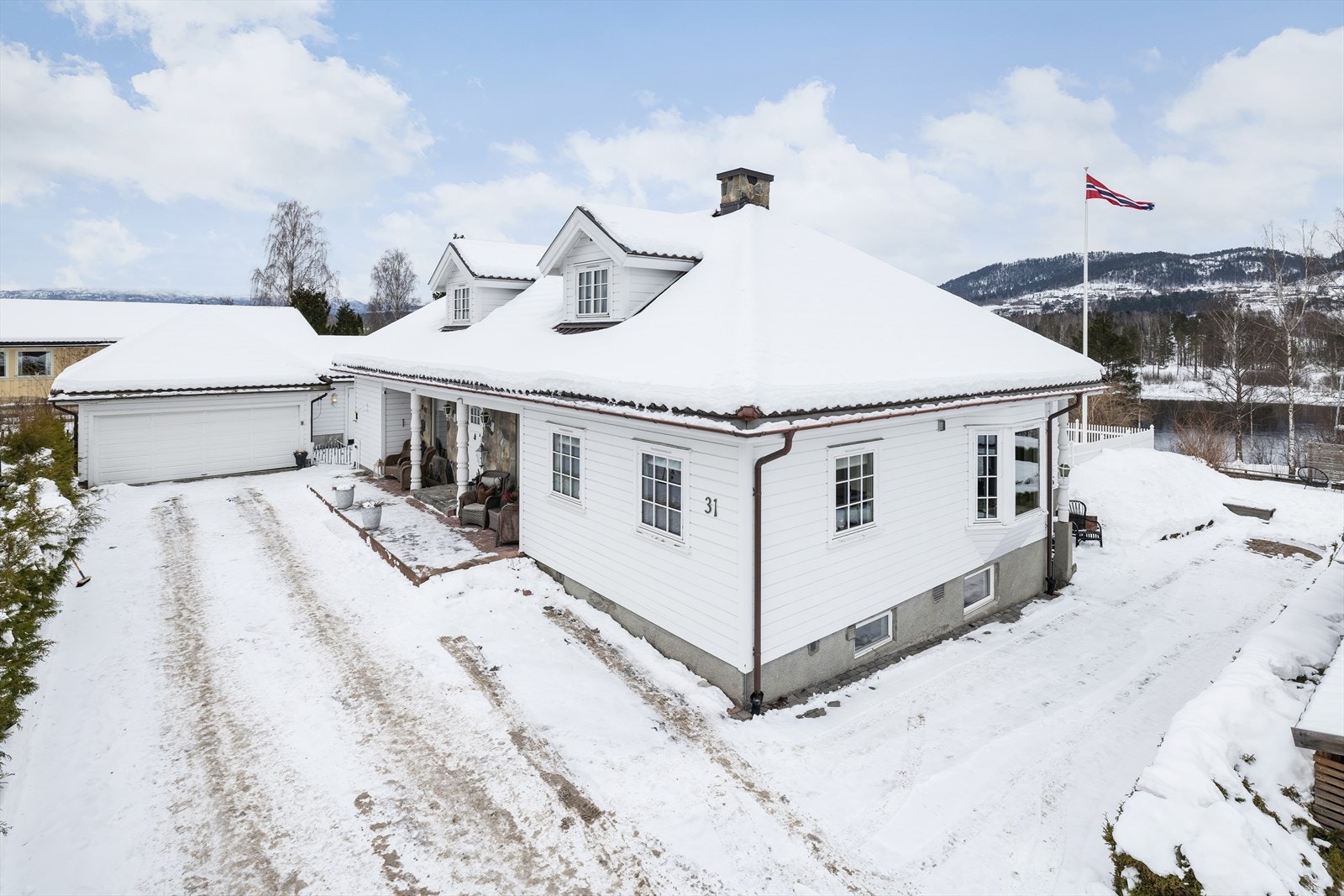 Man ankommer boligen fra et pent overbygget inngangsparti. Inngangspartiet fremstår svært innbydende med en fin steinfasade. Galleribilde