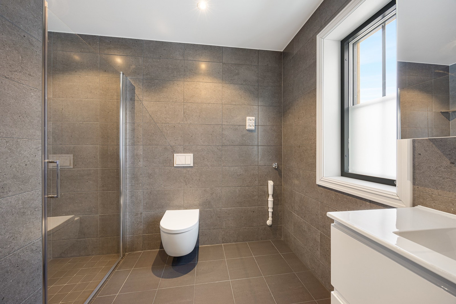 Badet har behagelige varmekabler i gulvet og opplegg for vaskemaskin. Galleribilde