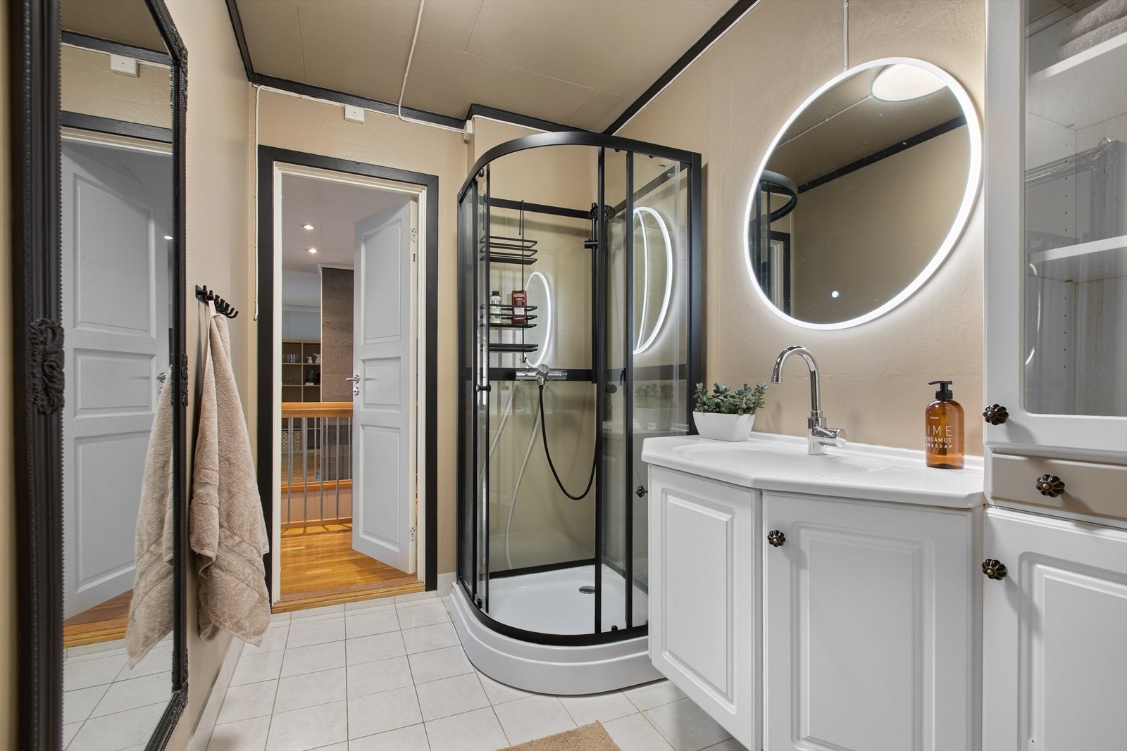 Badet i første etasje er praktisk innredet med servantmøbel og dusjkabinett. Galleribilde