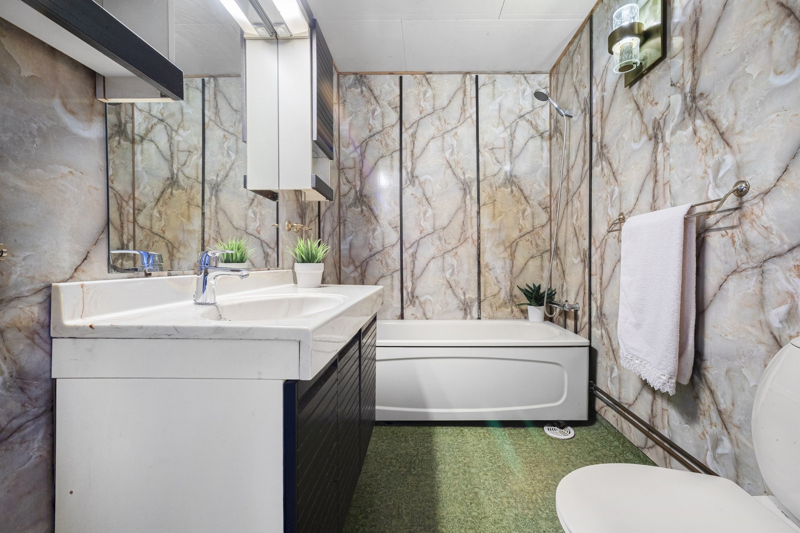 Baderom av eldre standard med gulvbelegg og vegger med baderomsplater Galleribilde