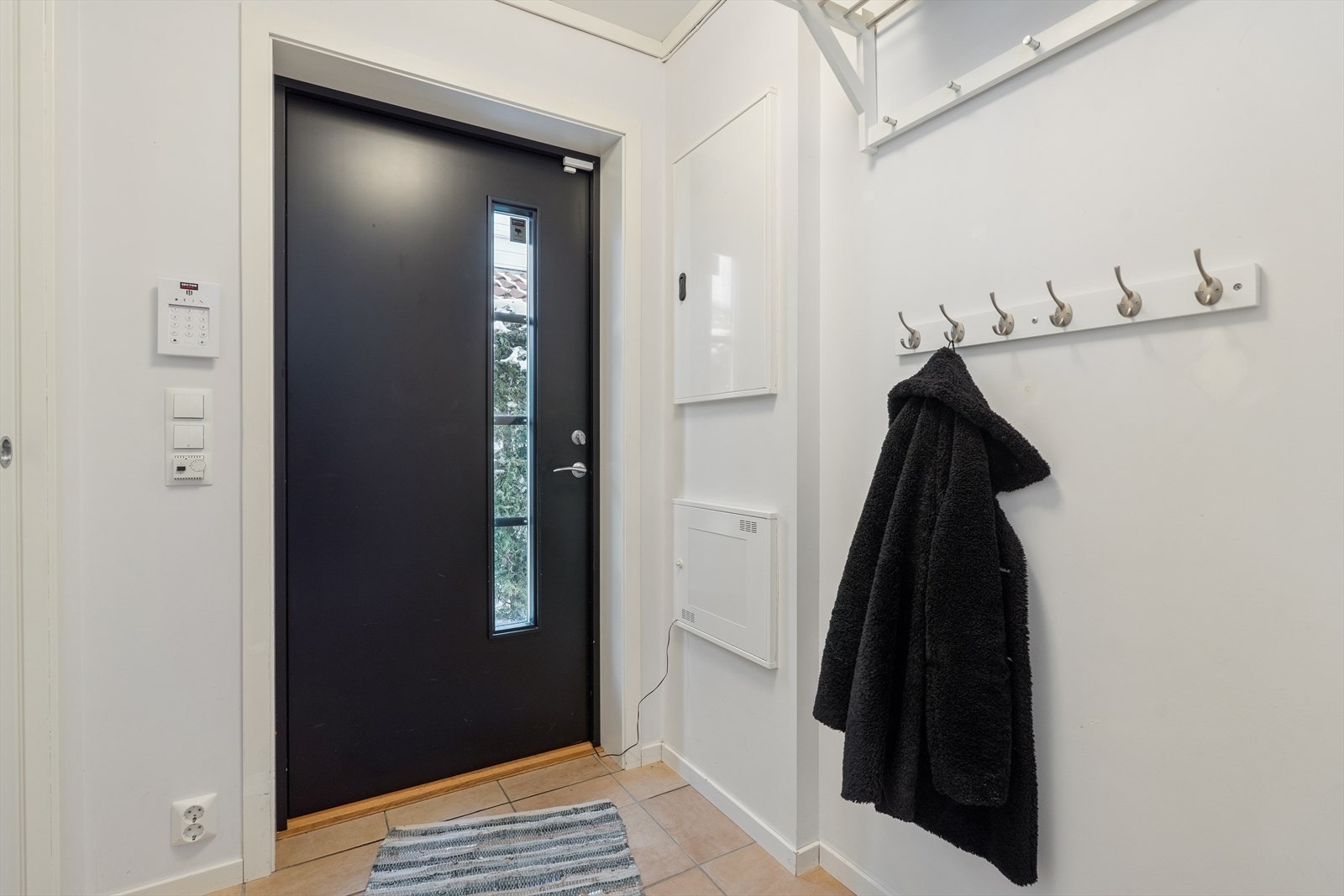 Det første som møter deg når du kommer inn er en entré med plass til sko og yttertøy. - Gulvvarme under fliselagt gulv Galleribilde