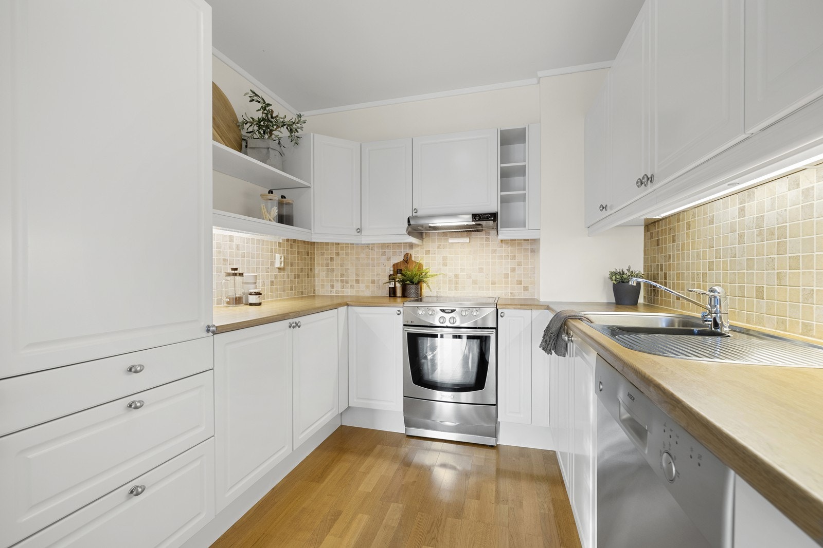 Detaljer som belysning under overskap og åpne hylleløsninger. Galleribilde