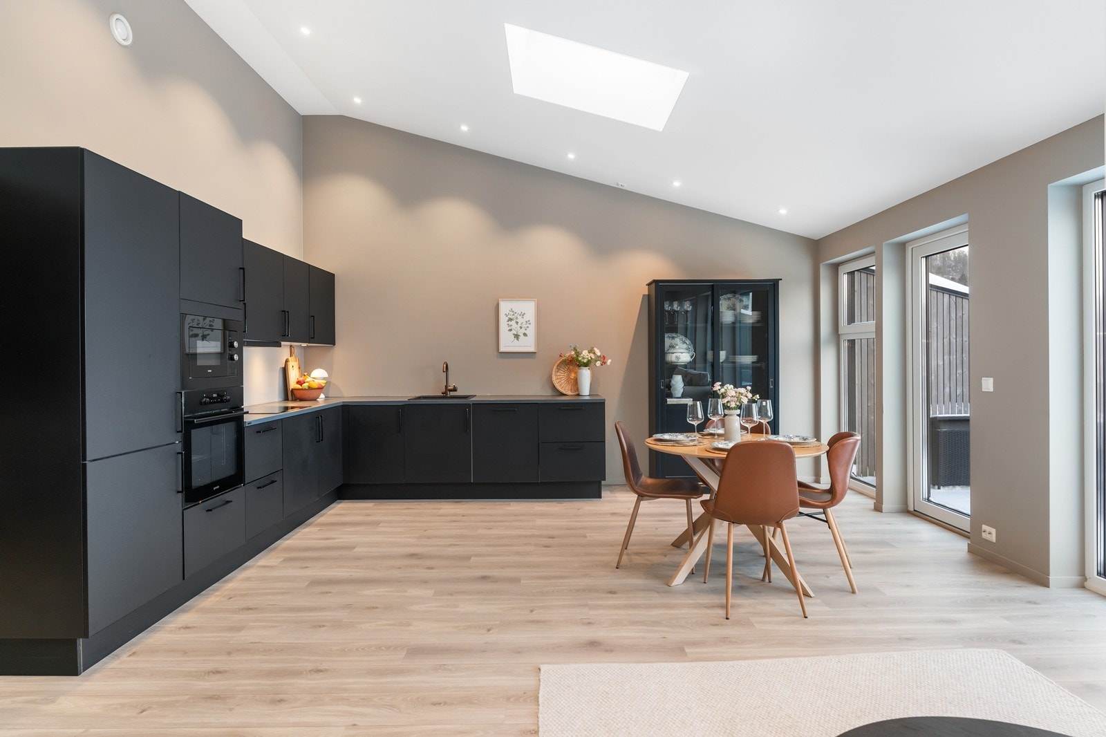 Stue og kjøkken har ekstra takhøyde. Her er listefritt tak med downligths som gir et moderne peg. Galleribilde