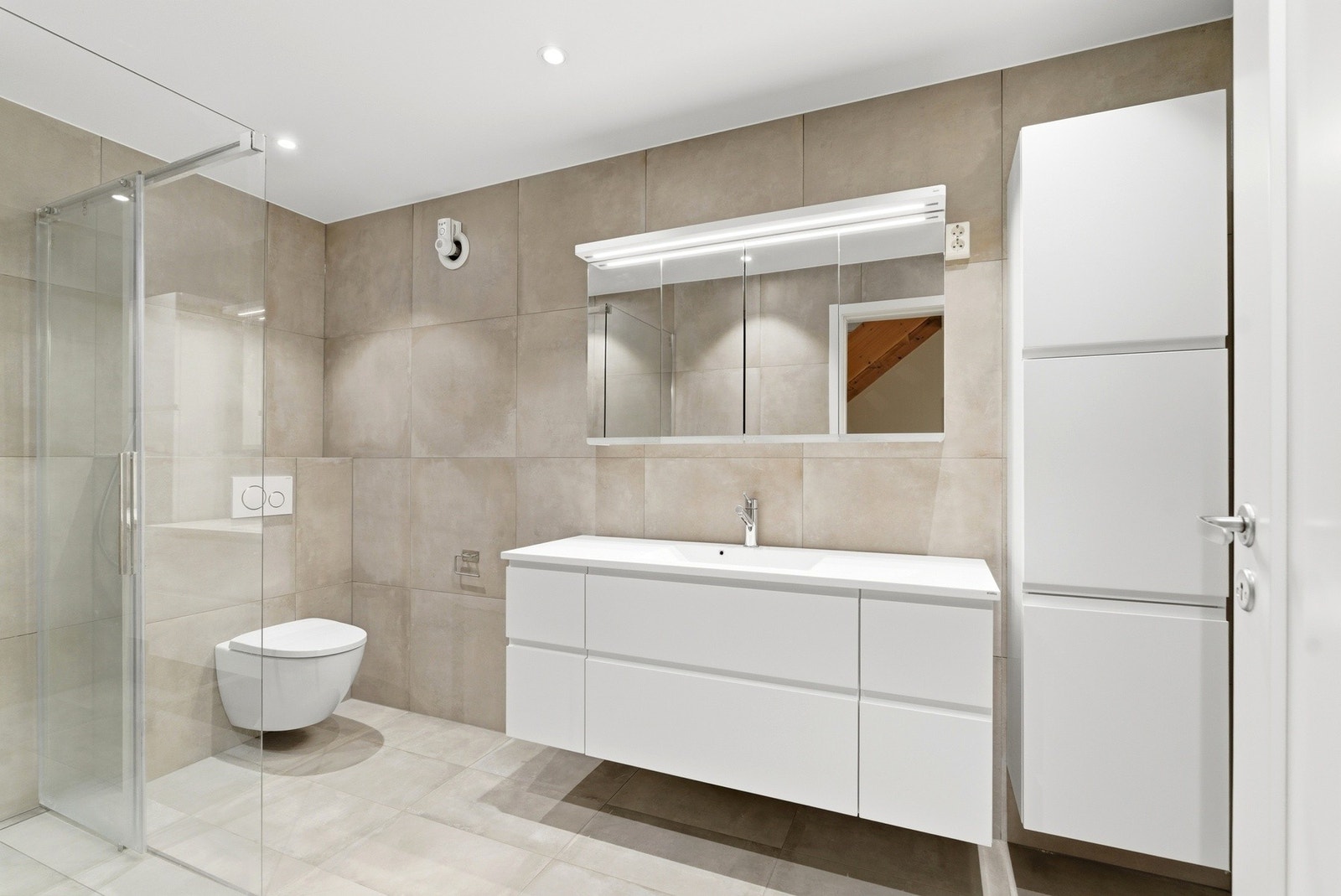 Lekkert bad som er modernisert i 2019, med stilren baderomsinnredning, som inkluderer nedfelt servant, veggmontert toalett og dusjhjørne med dusjvegger. Downlights i himlingen. Galleribilde