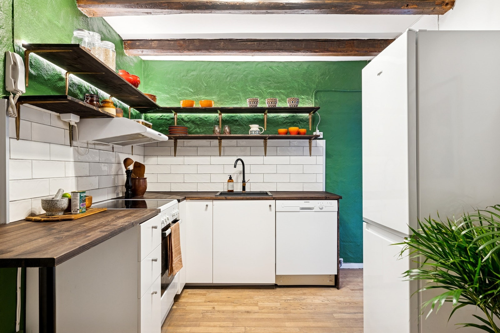 Innredningen har rene, slette fronter og benkeplate av oljet furu, med avsatt plass til frittstående hvitevarer. Galleribilde