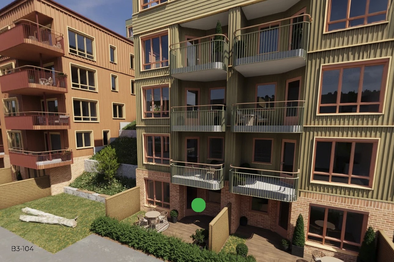 Leiligheten ligger på enden av bygget med en beplantet grønn skråning som nærmeste nabo. Galleribilde