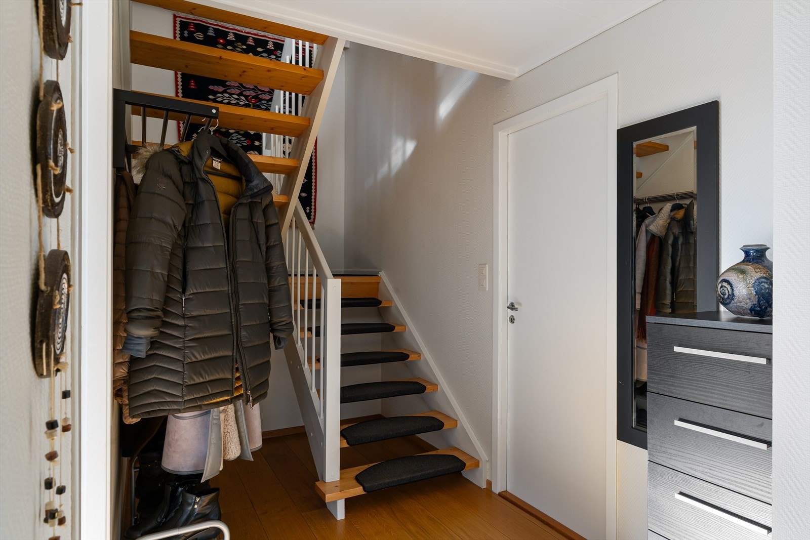 Fra trappen i første etasje tar man seg ned til underetasjen som inneholder kjellerstue/soverom, 2 soverom, bad, vaskerom og tre boder for lagring/oppbevaring. Galleribilde