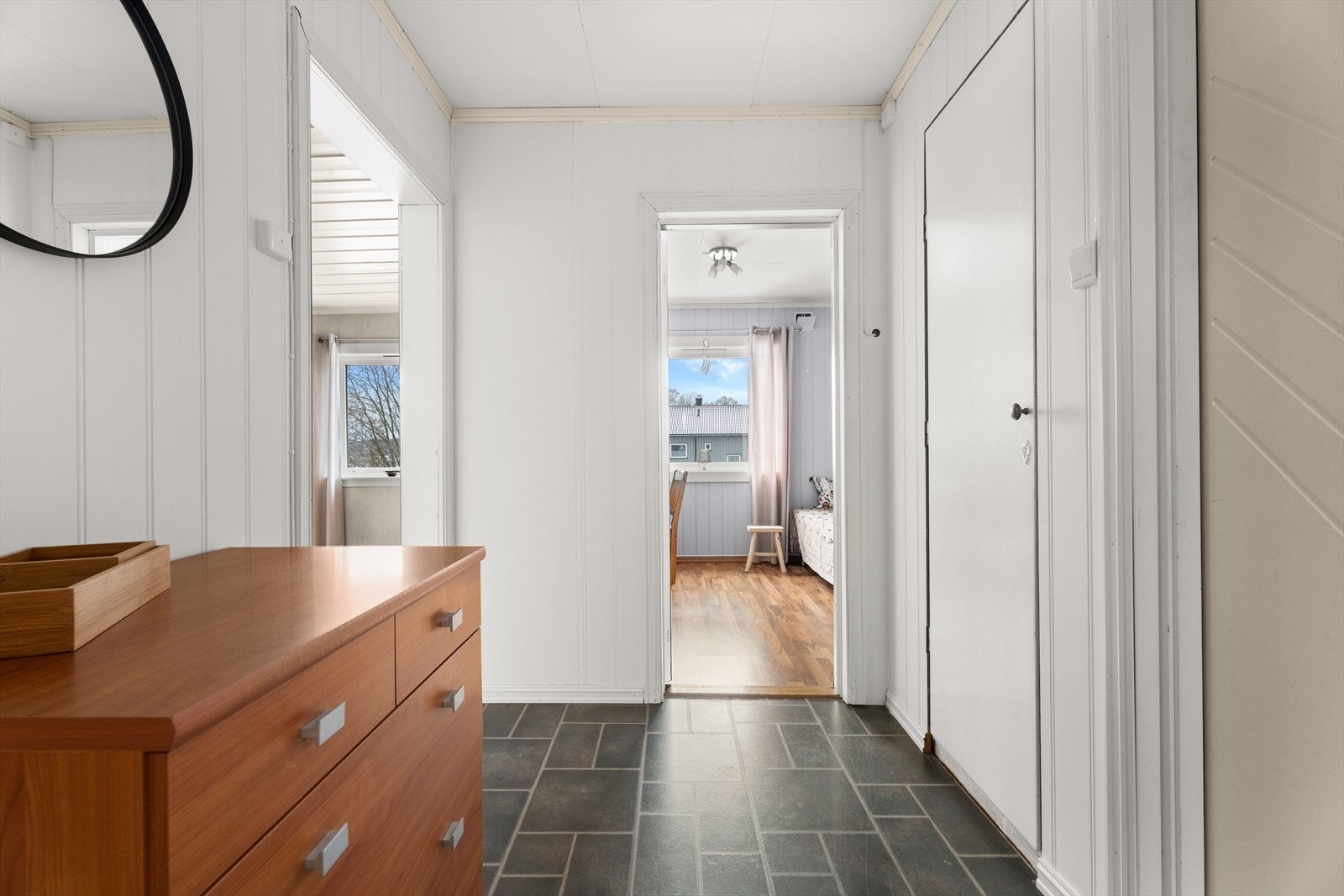 Panelplater på veggene gir gangen et lyst og helhetlig preg. Galleribilde