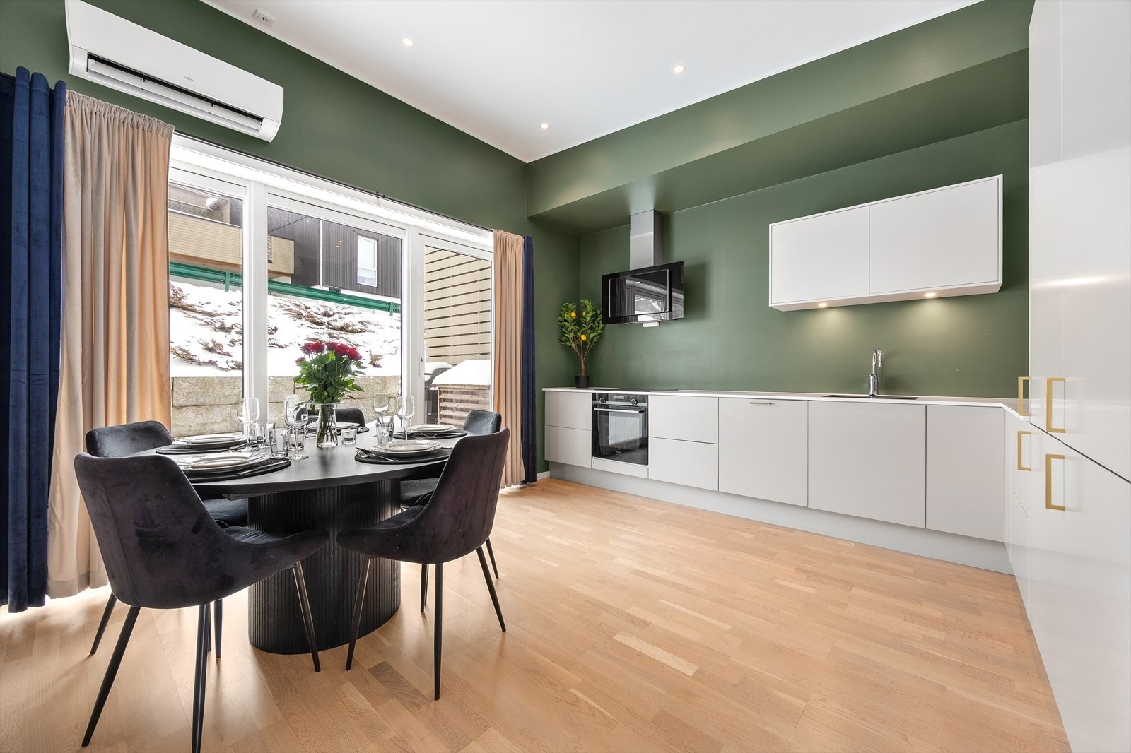 Kjøkkenet har en stilren innredning med glatte, hvite fronter og god benkeplass. Galleribilde