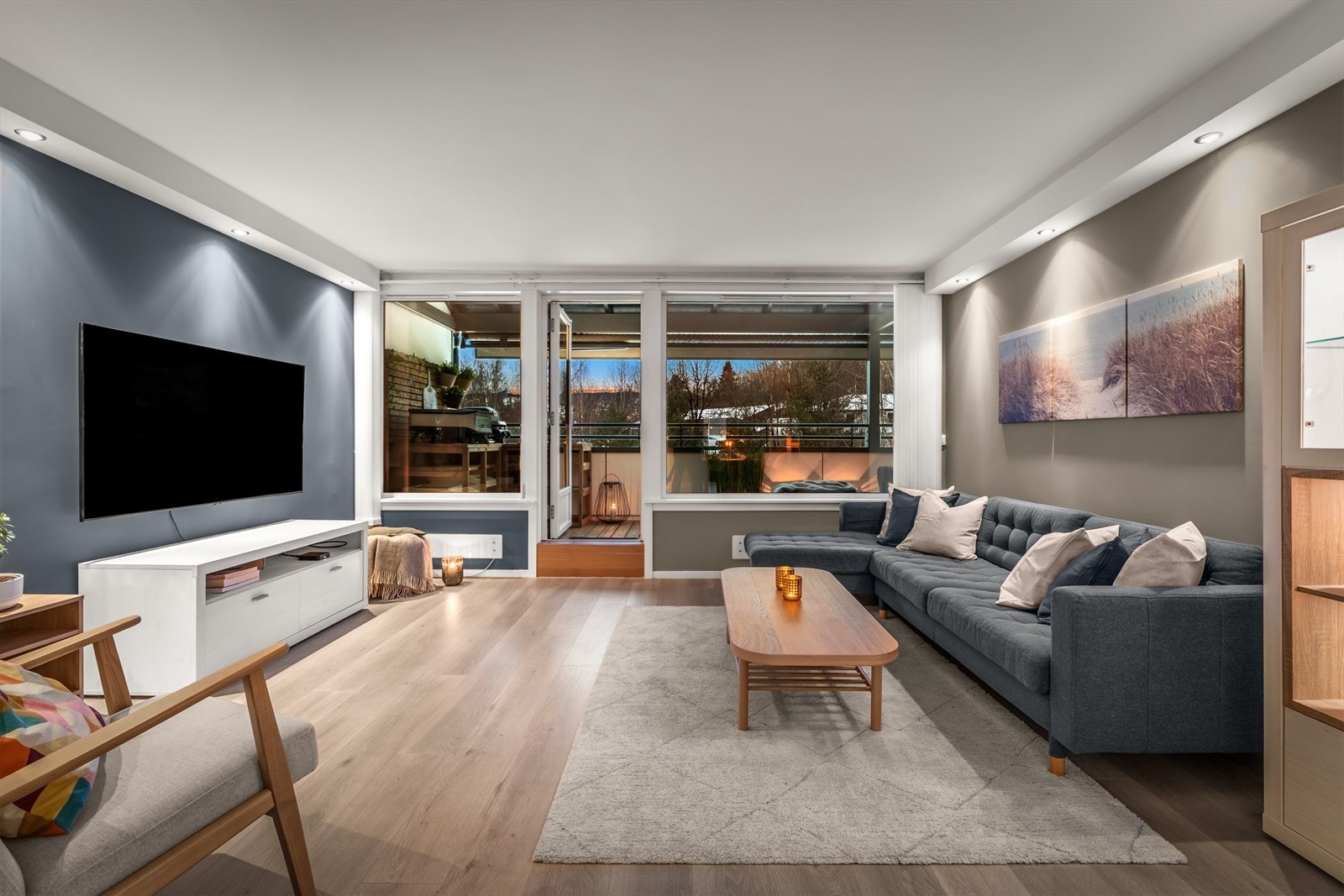 Stuen er malt i en lys fargepalett som sammen med de store vindusflatene gir en god atmosfære i boligen. Galleribilde