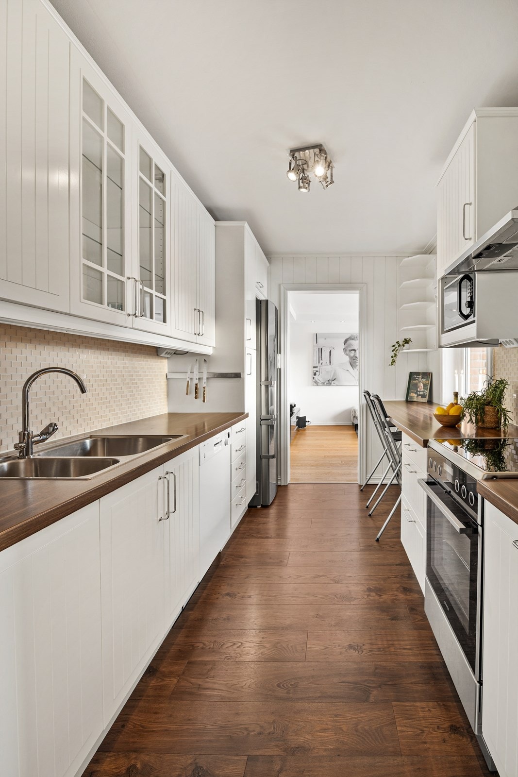 Benkeplate av laminat. Benkeskapsbelysning og stikkontakter over kjøkkenbenk Galleribilde