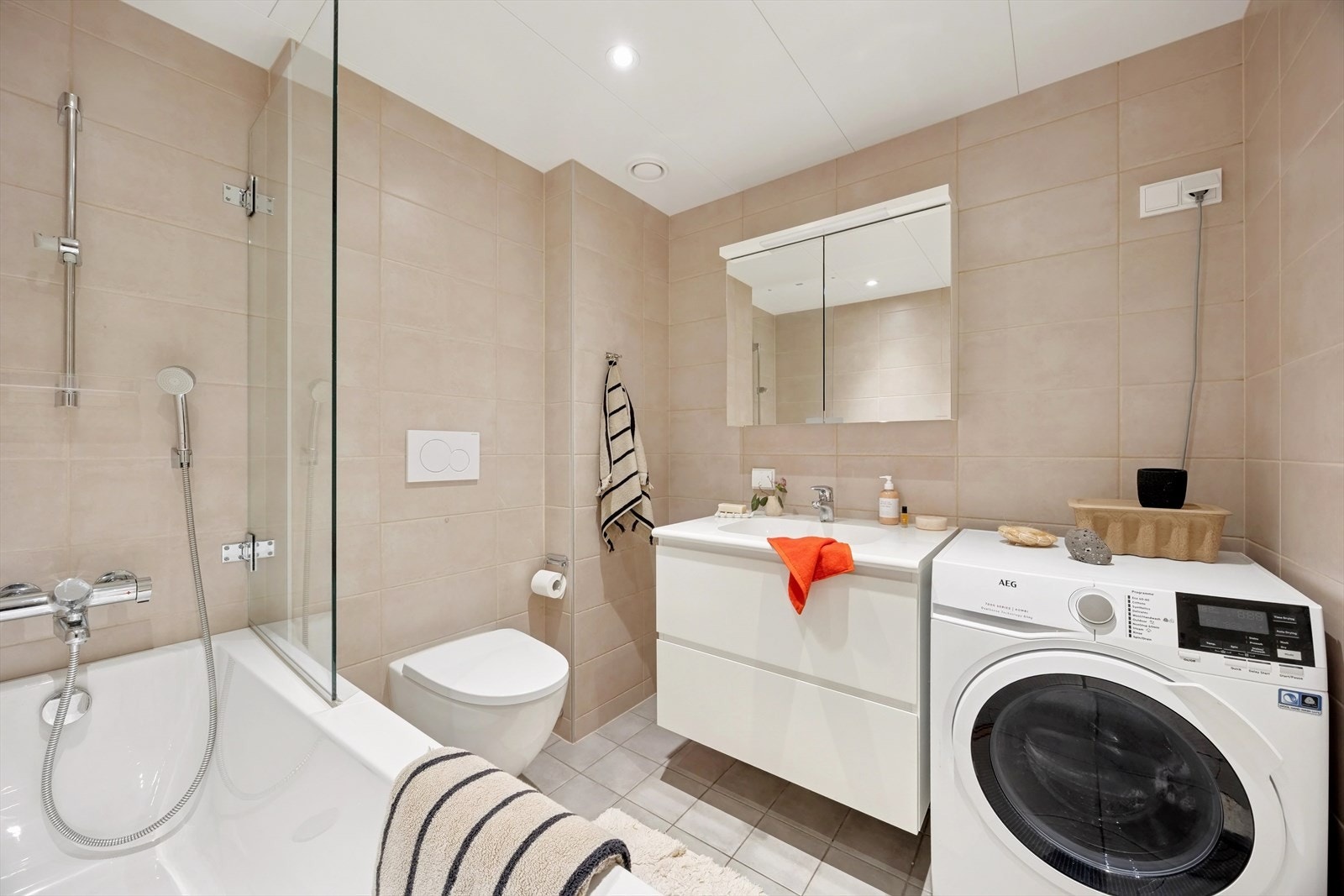 Det delikate og store badet har fliser på gulv og vegger. Galleribilde