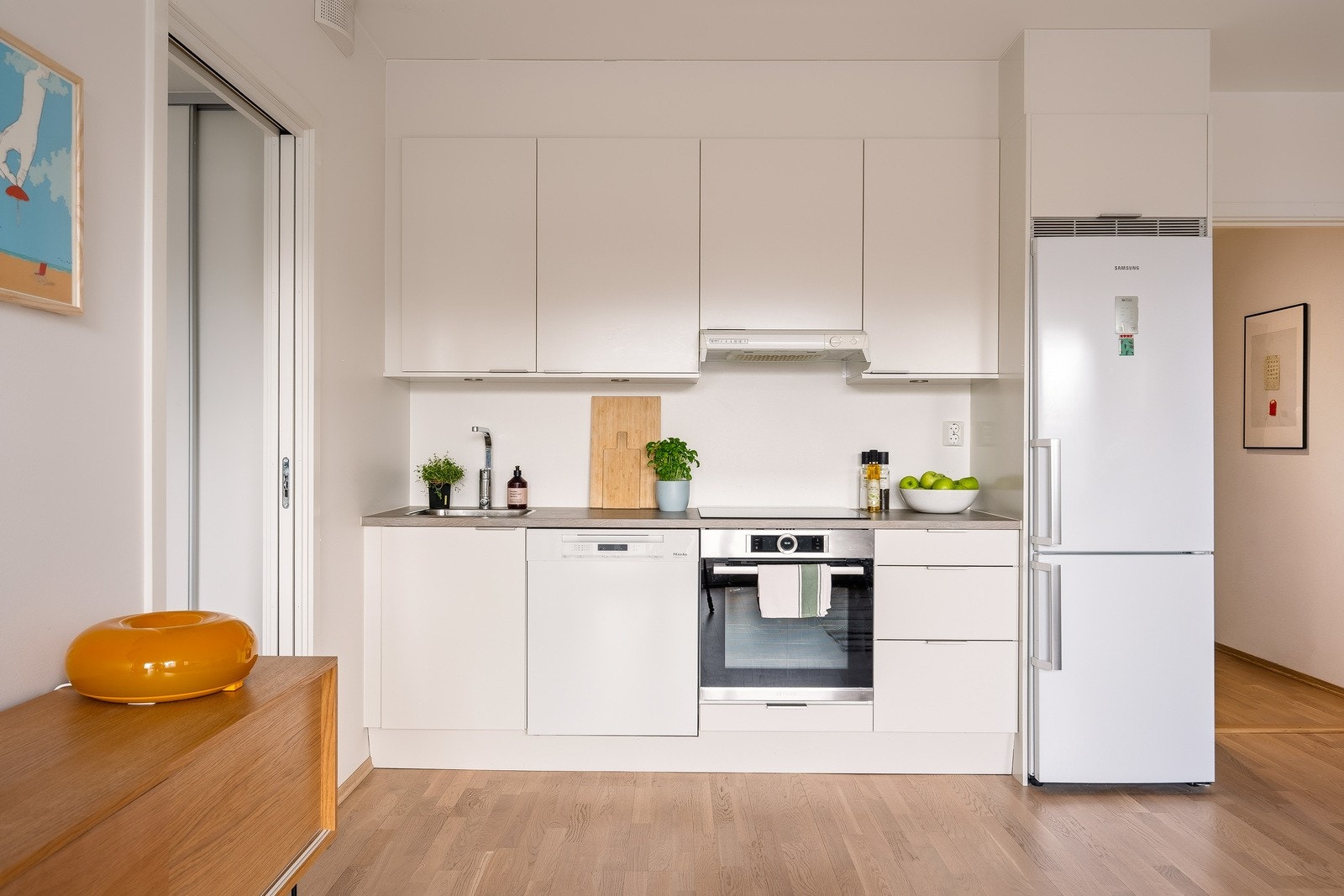 Kjøkkenet har en stilren innredning med glatte fronter og benkeplate i laminat. Galleribilde