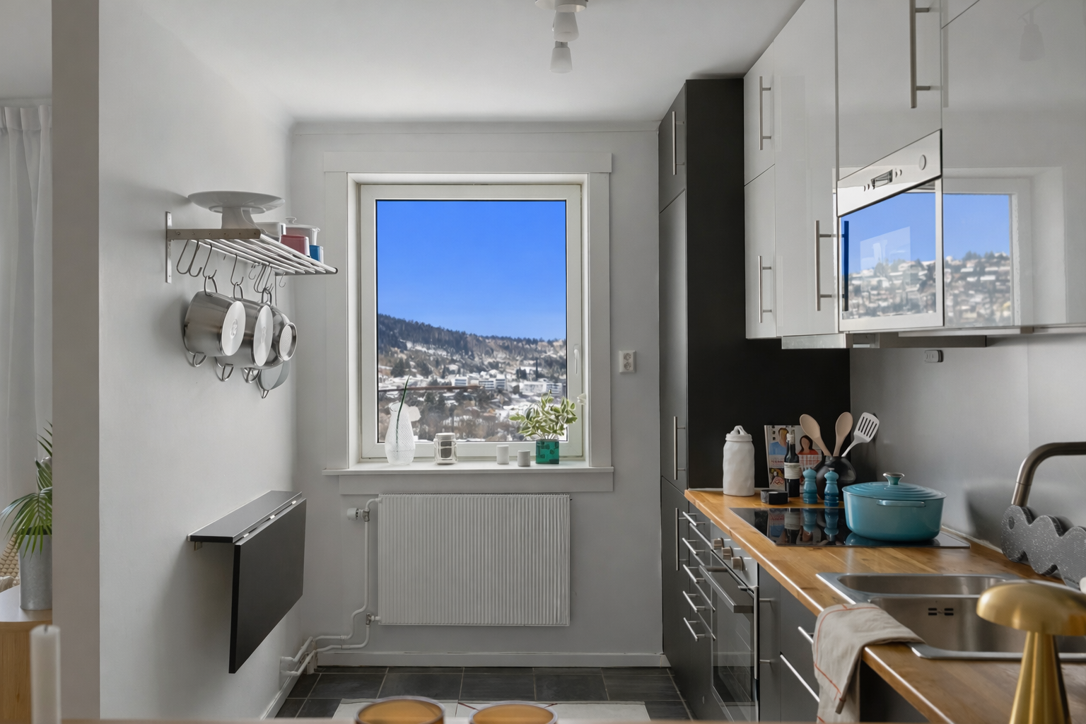 Vindu sørger for godt lys også på kjøkkenet. En lettvegg mellom kjøkkenet og stue skiller de to sonene fint, og gjør det også enklere å møblere i forhold til TV. Galleribilde