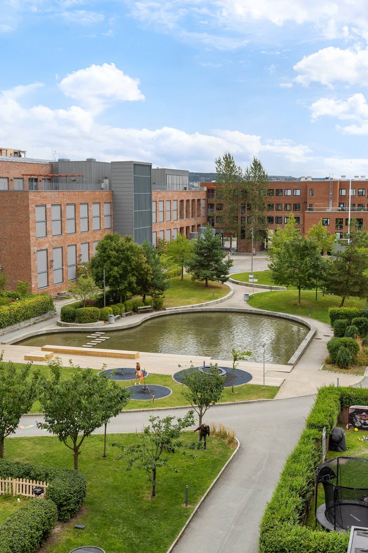 Barnevennlig og idyllisk boområde med lekeplasser og vannspeil rett utenfor blokken. Galleribilde