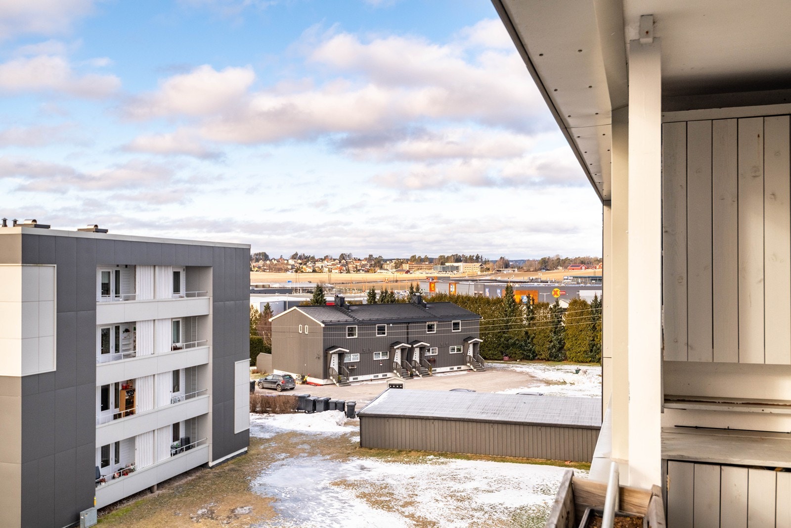 Fra balkongen er det utsikt mot nærliggende boligområder og grøntarealer. Galleribilde
