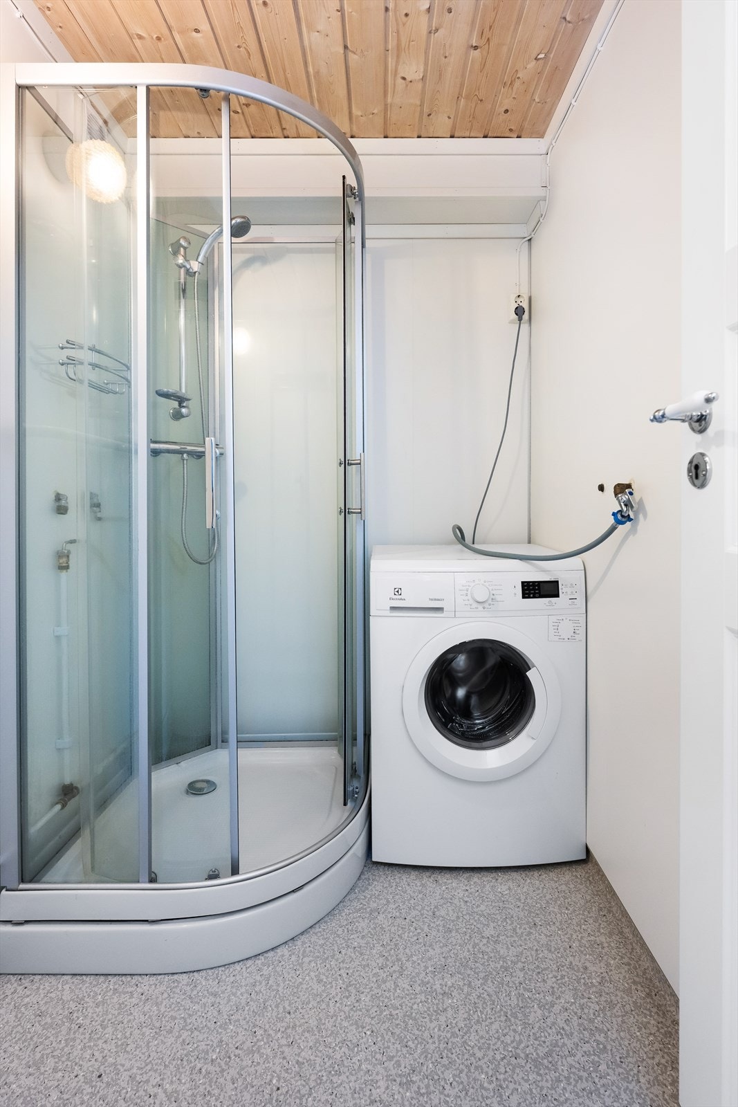 Fra kjøkkenet er det tilkomst til bad med dusjkabinett og vaskemaskin/tørketrommel. Galleribilde