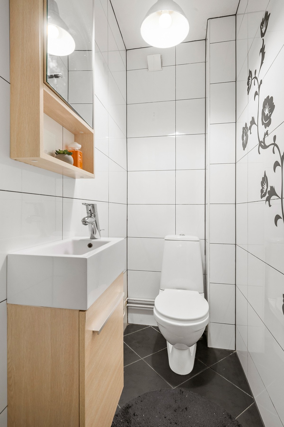 Praktisk og separat, flislagt wc med servant m/over- og underskap. Galleribilde