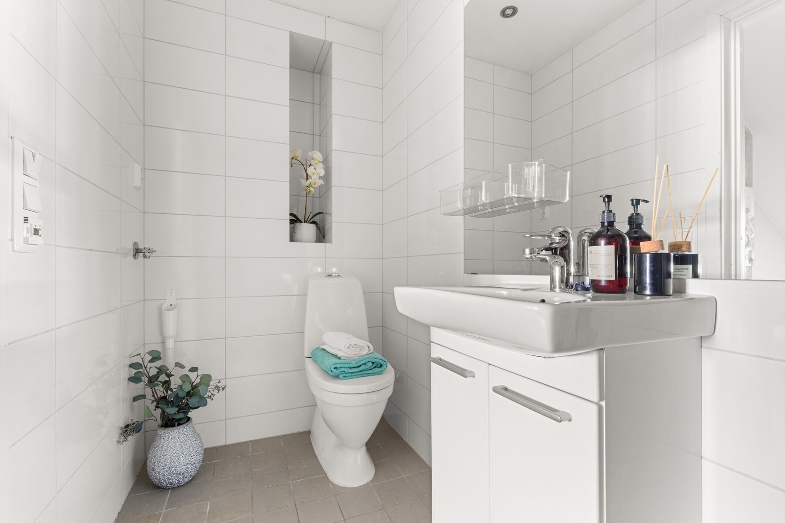 Dusj med innfellbare glassvegger, servant med skap, speil med lys, gulvmontert wc,. Galleribilde