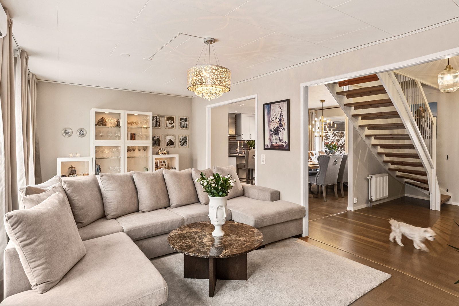 Lys og romslig stue med store vindusflater og direkte utgang til den solrike, flislagte terrassen - et perfekt samlingspunkt for hele familien Galleribilde