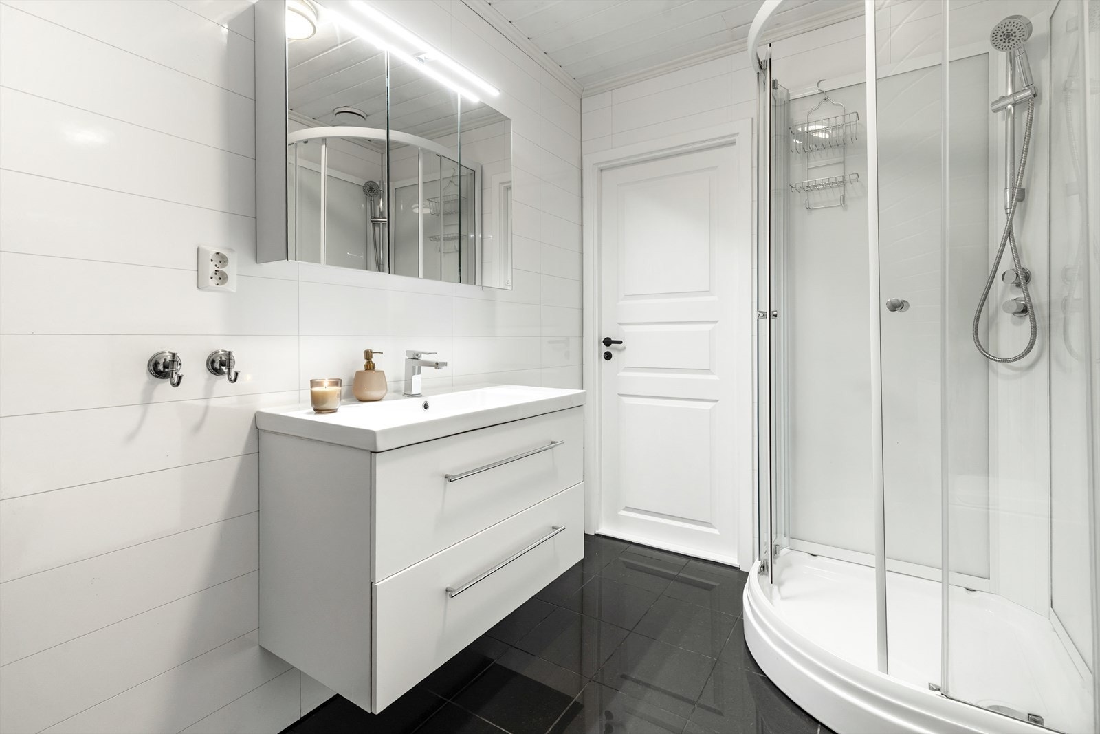 Badet i 2. etasje er innredet med toalett, servant m/underskap, speilskap og dusjkabinett. Galleribilde