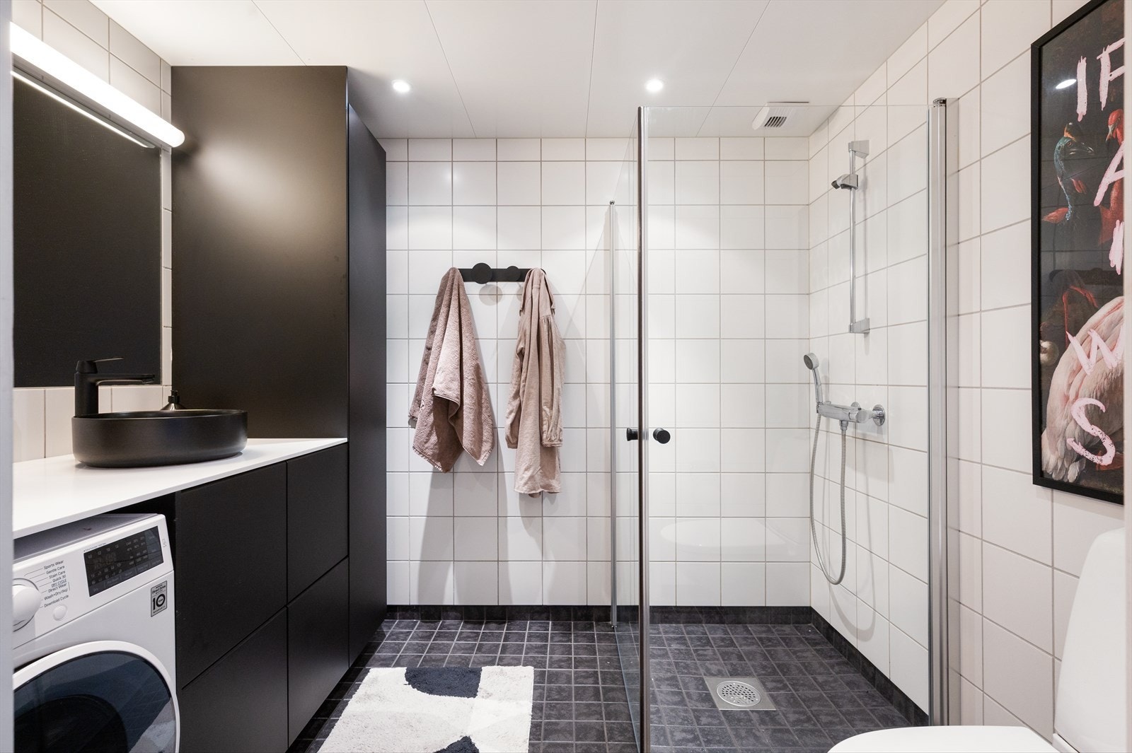 Pent, flislagt baderom fra byggeår med dusjnisje og innfellbare dusjdører. Galleribilde