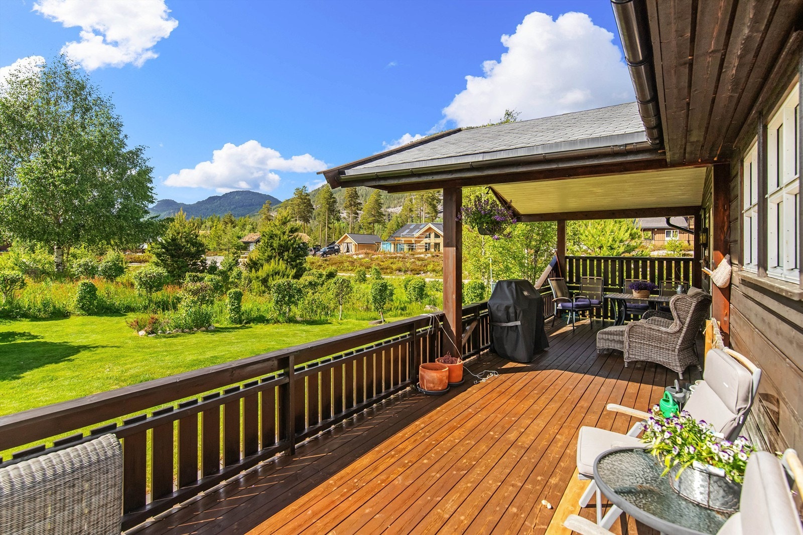 Flott tomt som er pent og lettholdt opparbeidet med plen og naturlig vegetasjon Galleribilde