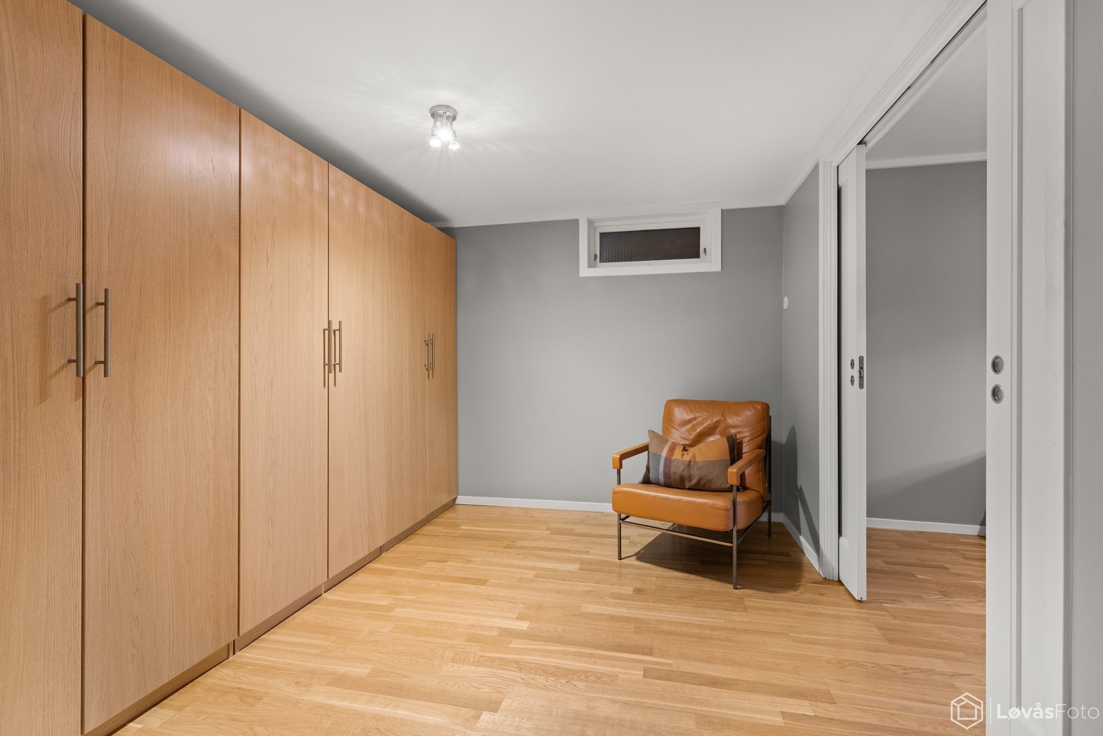 Praktisk omkledningsrom med garderobeskap og doble skyvedører inn til soverom 4 Galleribilde