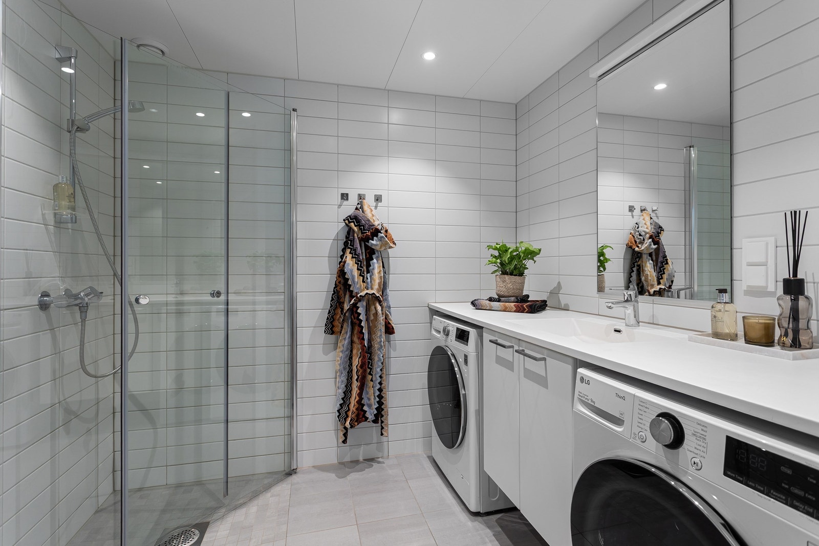 Badet fremstår som lyst og delikat med flislagte vegger og gulv i et tidløst uttrykk. Galleribilde