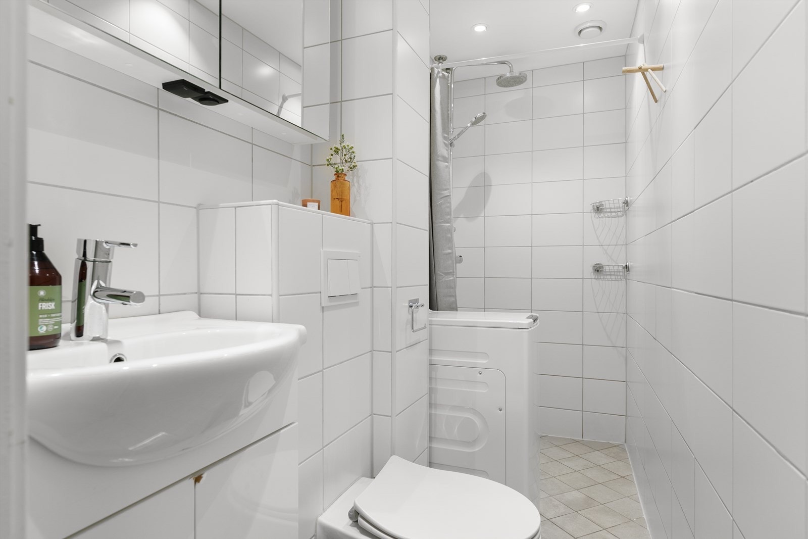 Her får dere dusjhjørne med forheng, vask med underskap, speilskap og vegghengt toalett. Det er også opplegg og plass til vaskemaskin. Galleribilde