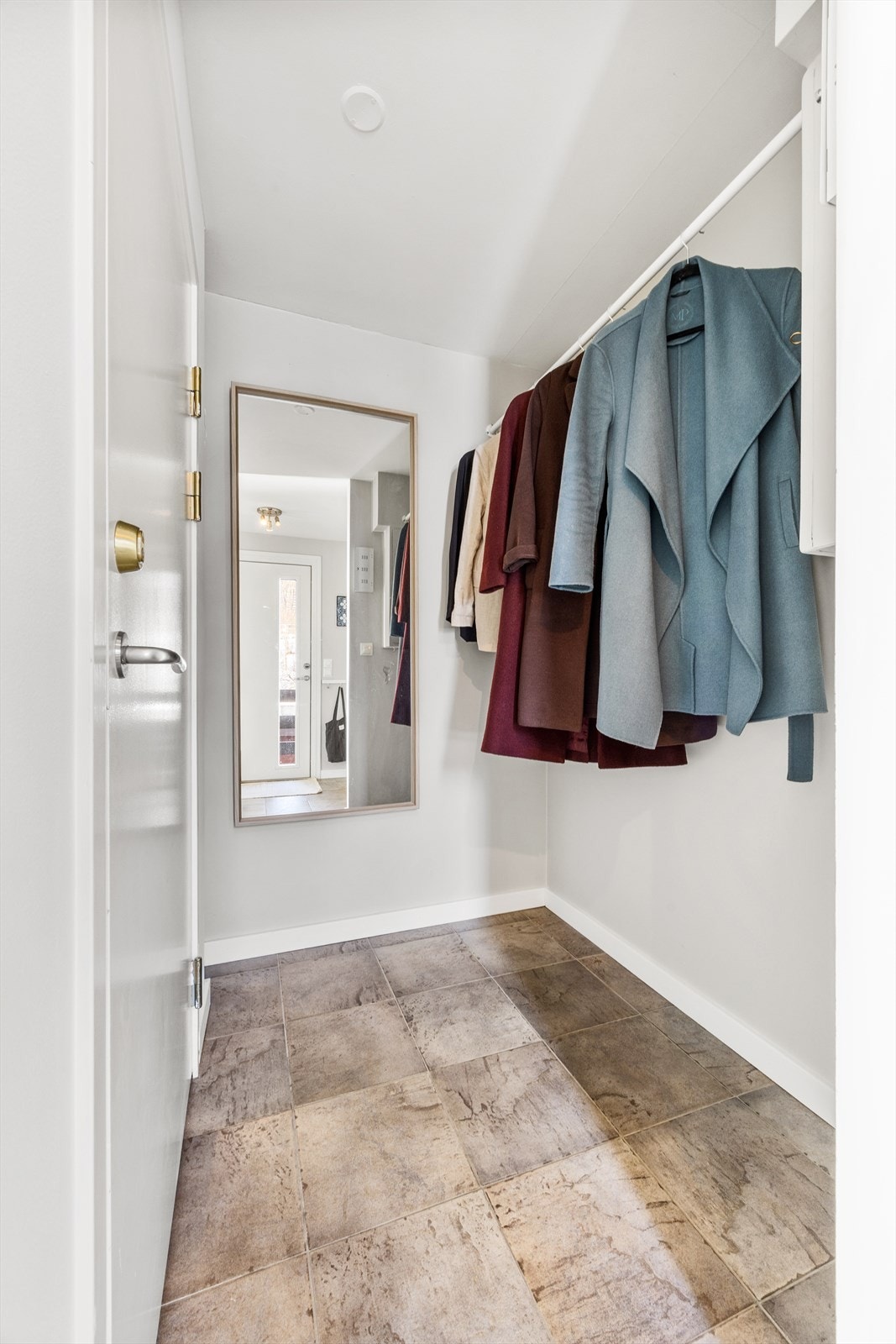 I tillegg til skyvedørsgarderoben har entrèen smart plass for å henge av seg yttertøy som gjør det enkelt å holde orden. Til venstre er det praktisk liten bod for ekstra lagring. Galleribilde