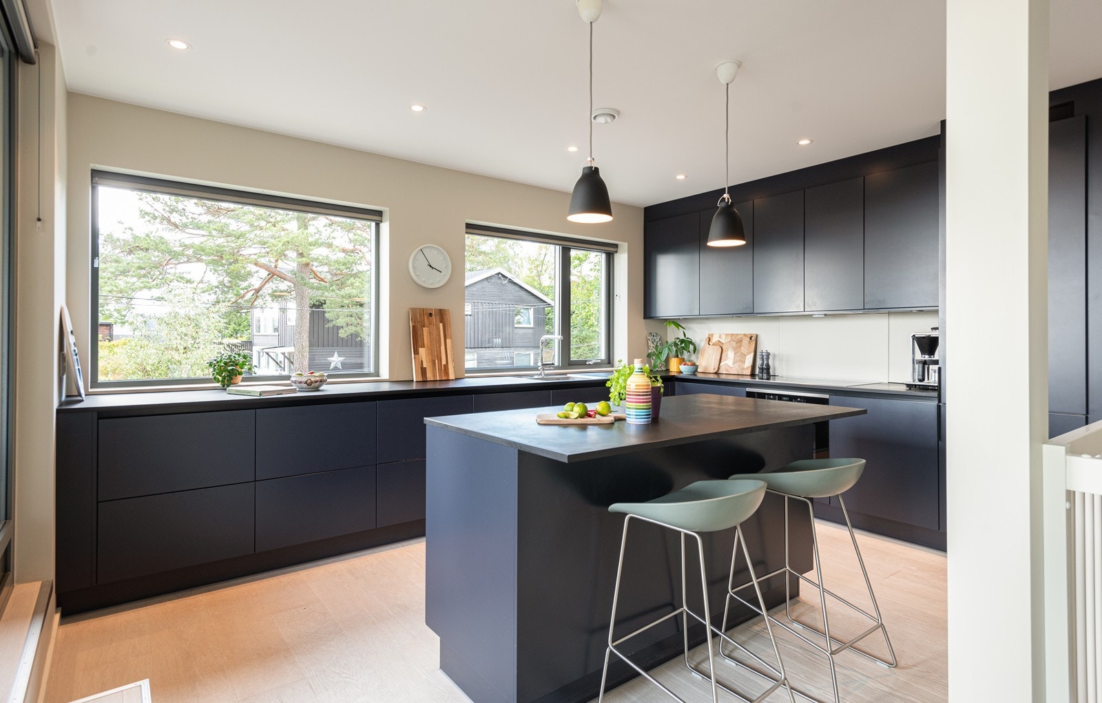 Moderne kjøkkeninnredning fra 2019 med praktisk kjøkkenøy og masse lys Galleribilde