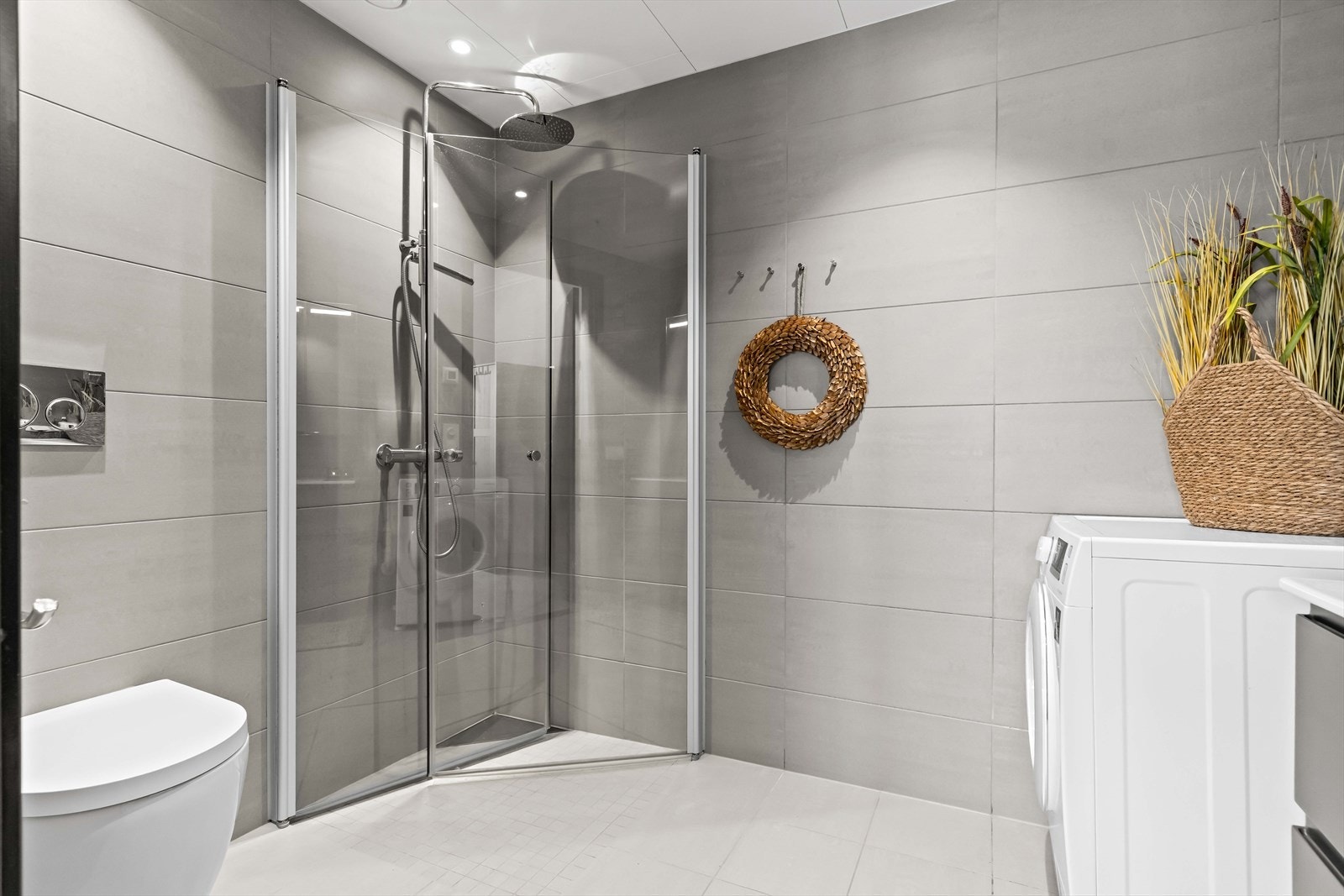 Dusj med glassvegger og vegghengt toalett gir et stilrent og funksjonelt bad. Galleribilde