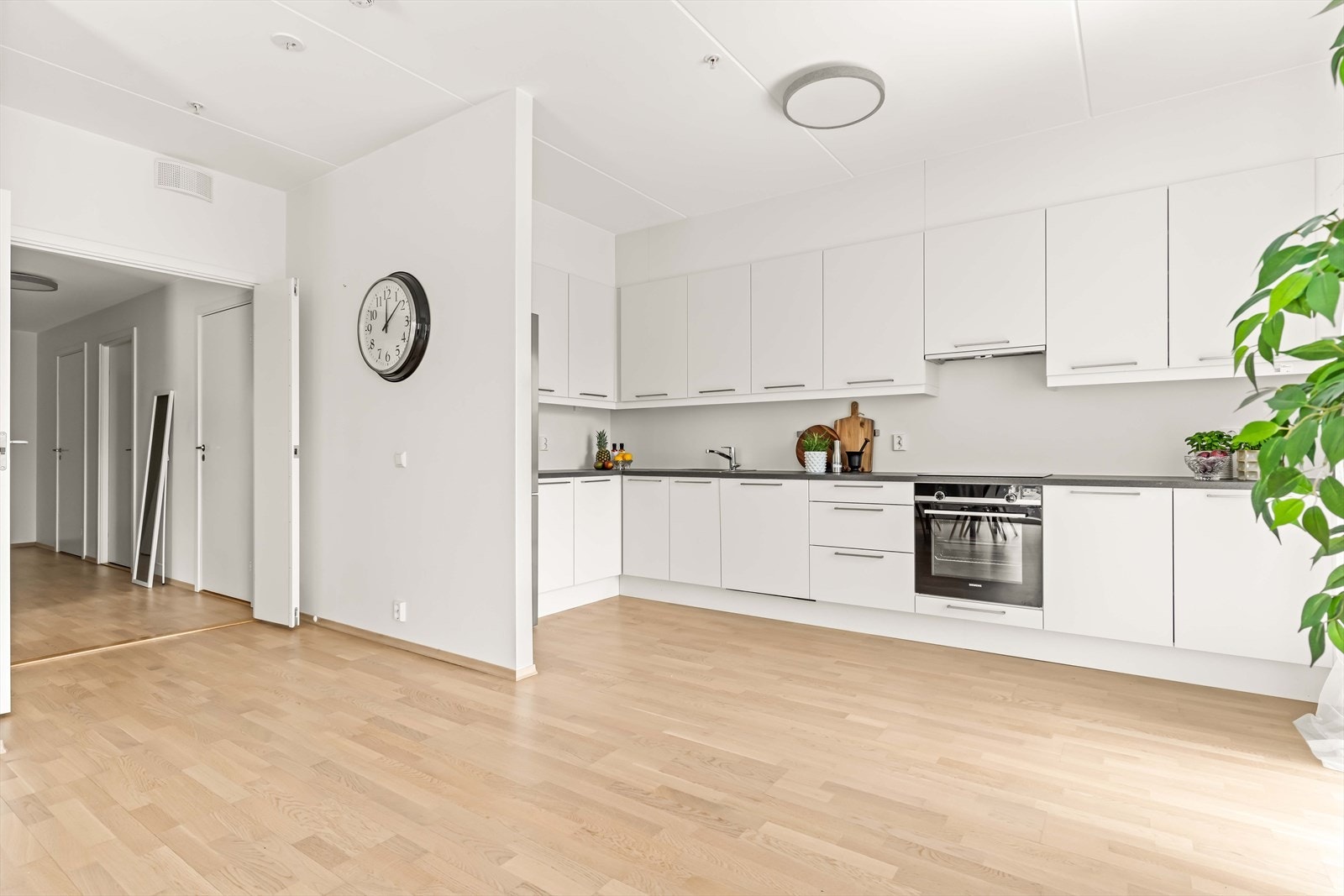 Kjøkkenet er moderne med glatte overflater, laminatbenkeplate og en oppvaskkum i stål. Galleribilde