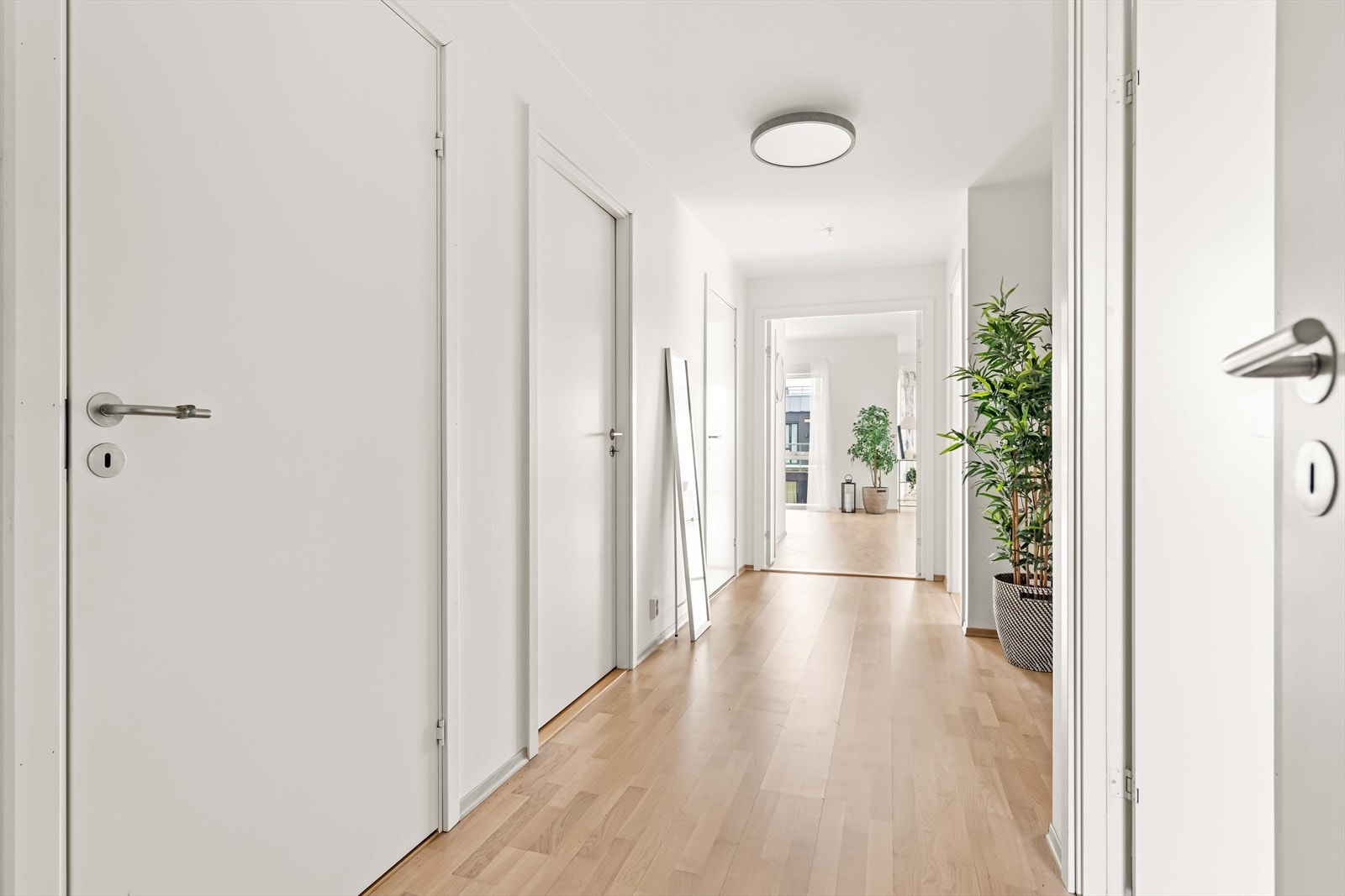 Her er det slette, hvitmalte vegger og parkettgulv, noe som er gjennomgående for resten av leiligheten. Galleribilde