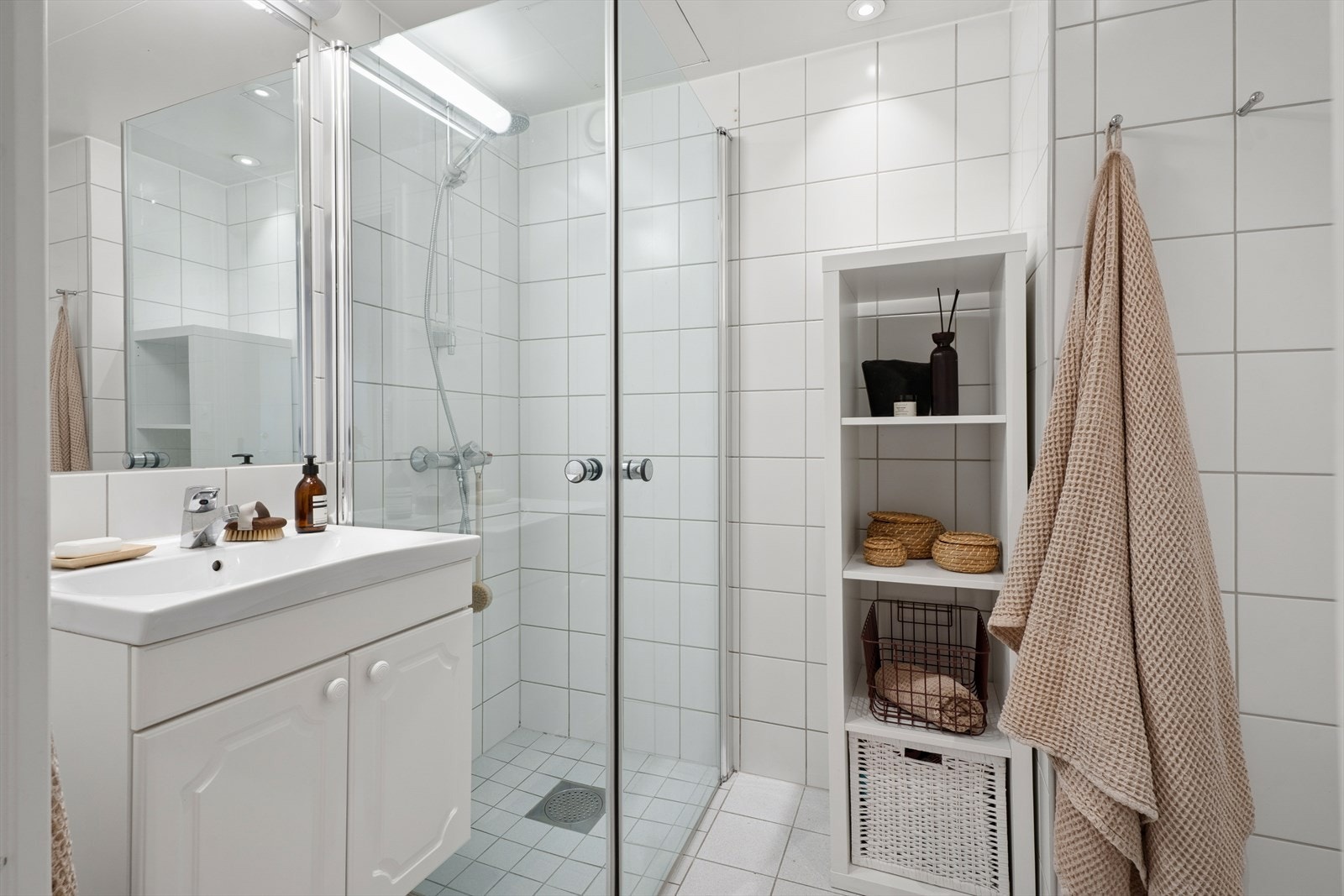 Innredning og garnityr på bad fremstår med: veggmontert WC, dusjplass med inn-utadslående dusjvegger og servant. Galleribilde