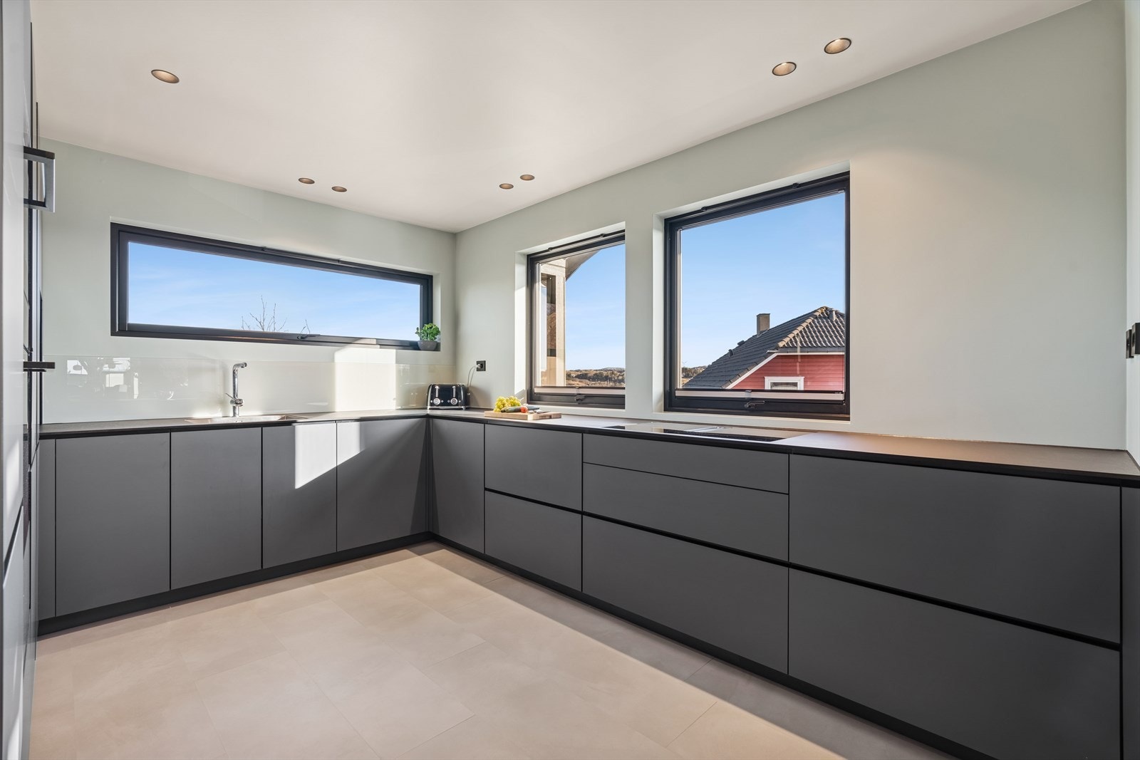 Kjøkkenet er innredet slik at matlagingen forenes med sosialt samvær. De generøse vinduene slipper inn mye naturlig lys. Galleribilde