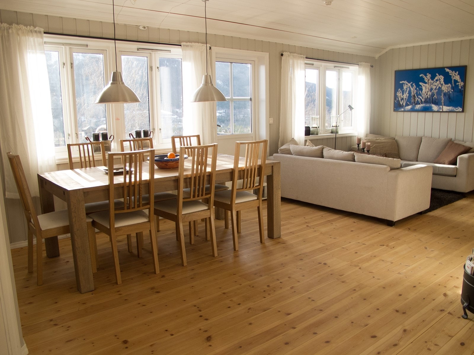 Leiligheten har en romslig stue med åpen løsning mot kjøkken og spiseplass, noe som gjør rommet sosialt og brukervennlig. Galleribilde