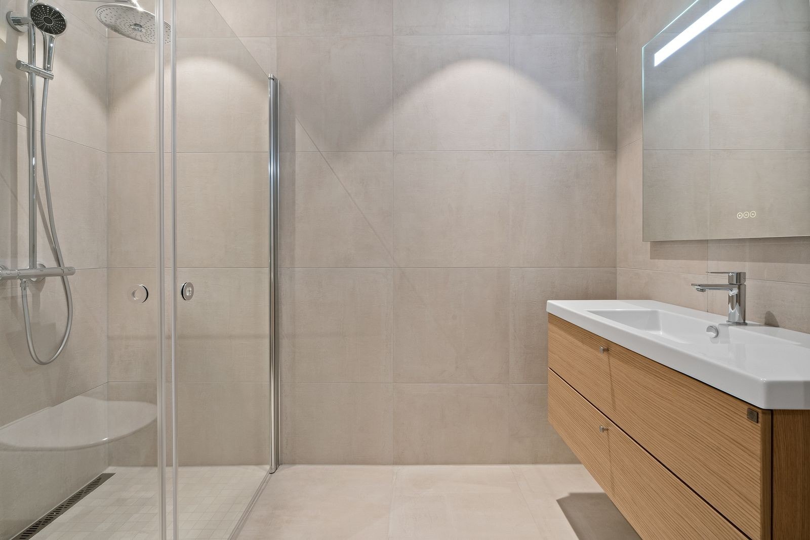 Fra entréen er det adkomst til badet. Badet er flislagt med lyse og moderne fliser. Galleribilde