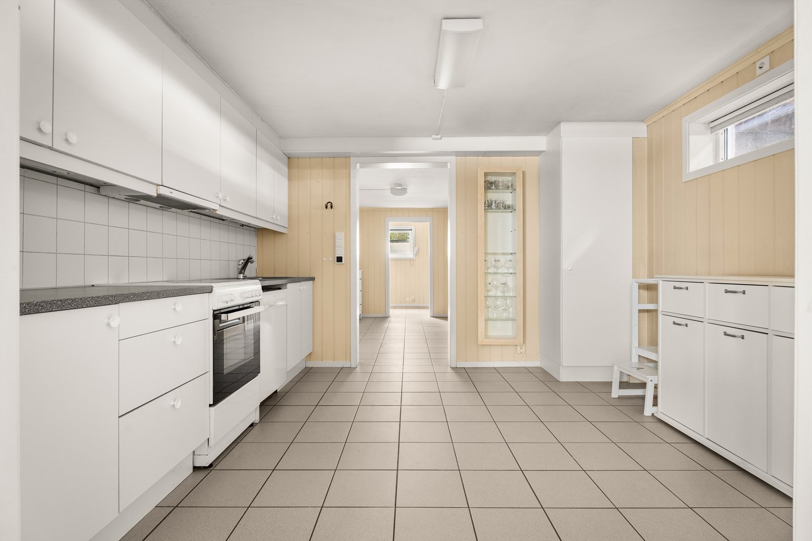 Kjøkkenet i kjelleren ble pusset opp i 2010 og har hvite, slette fronter. Galleribilde