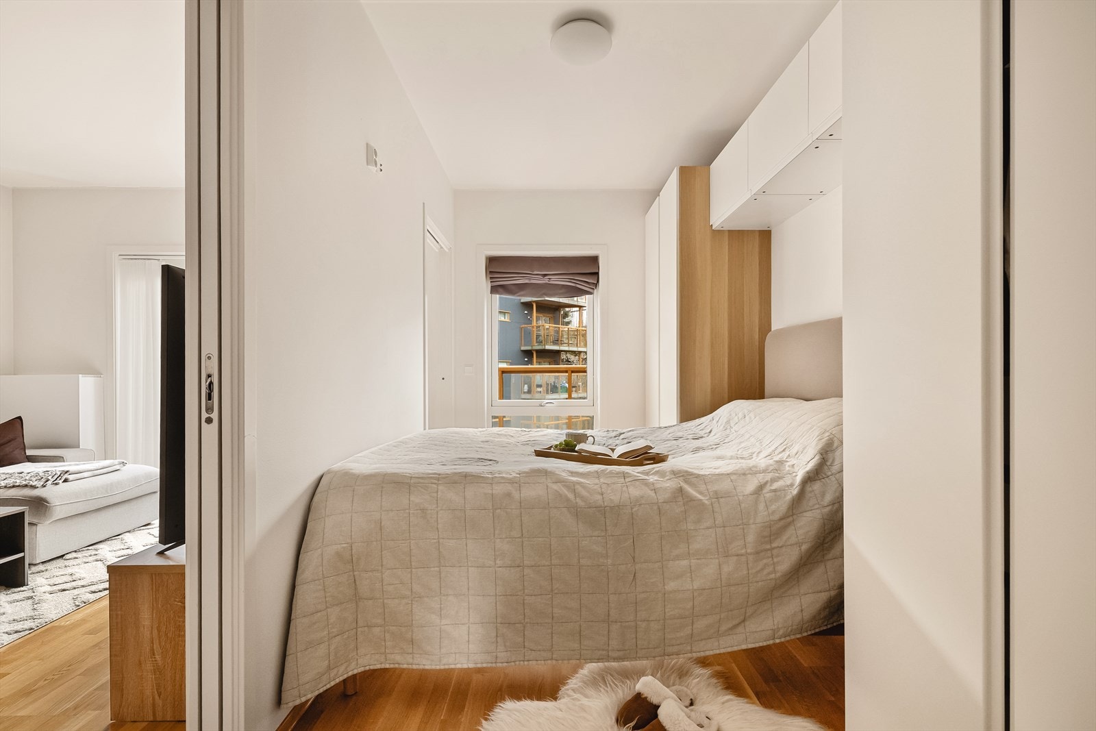 Smarte garderobeløsninger med skap på begge sider av seng, samt oppbevaring over. Galleribilde