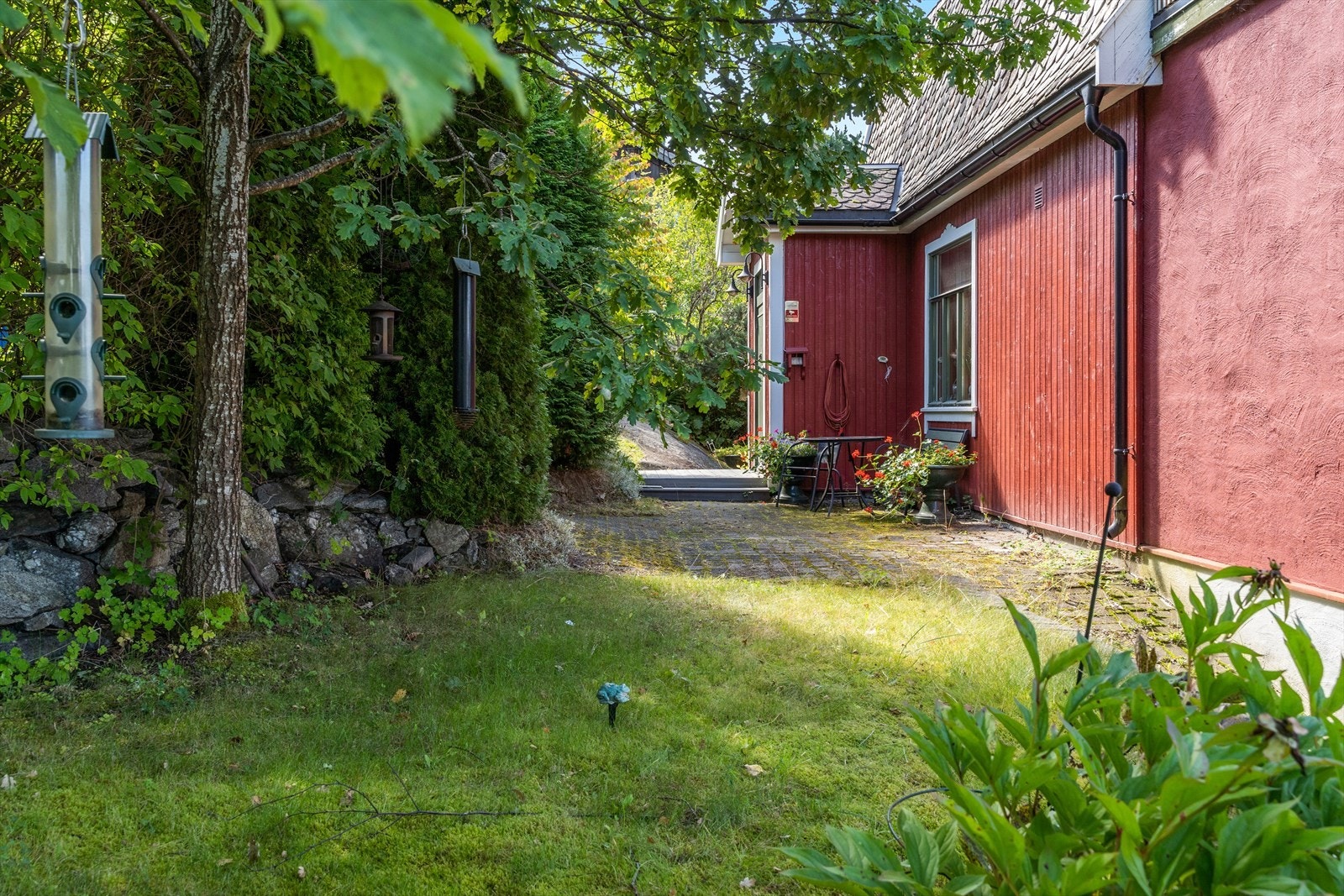 En grønn og frodig hage med plen og beplantning. Galleribilde