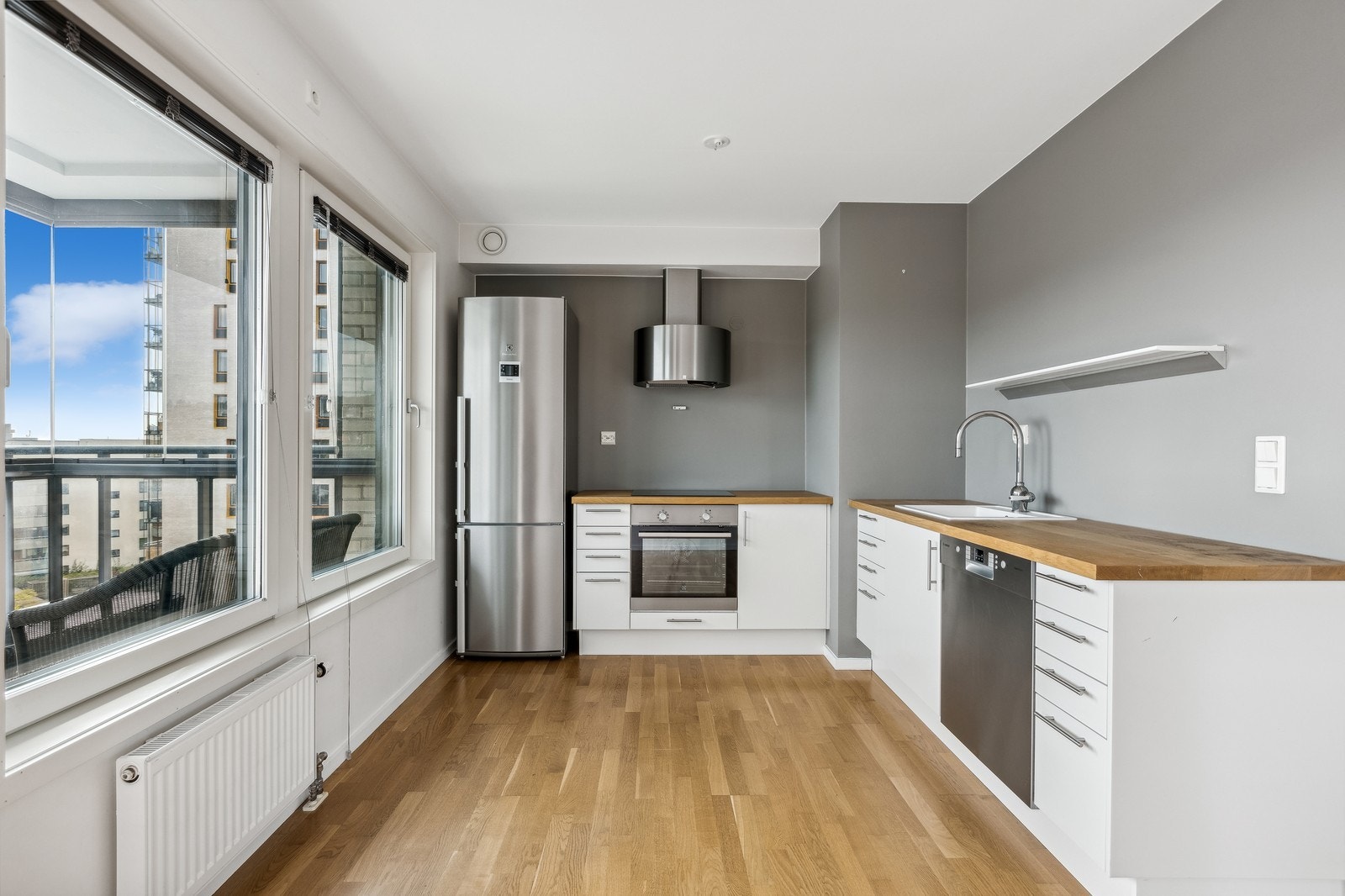 Stilig kjøkken med mye benkeplass. Alle hvitevarer integrert. Galleribilde