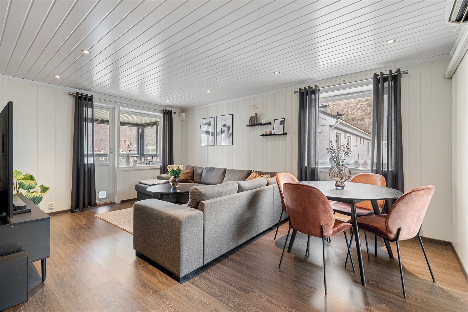 Romsleg stove som gir plass til stor sittegruppe og spisebord. Galleribilde