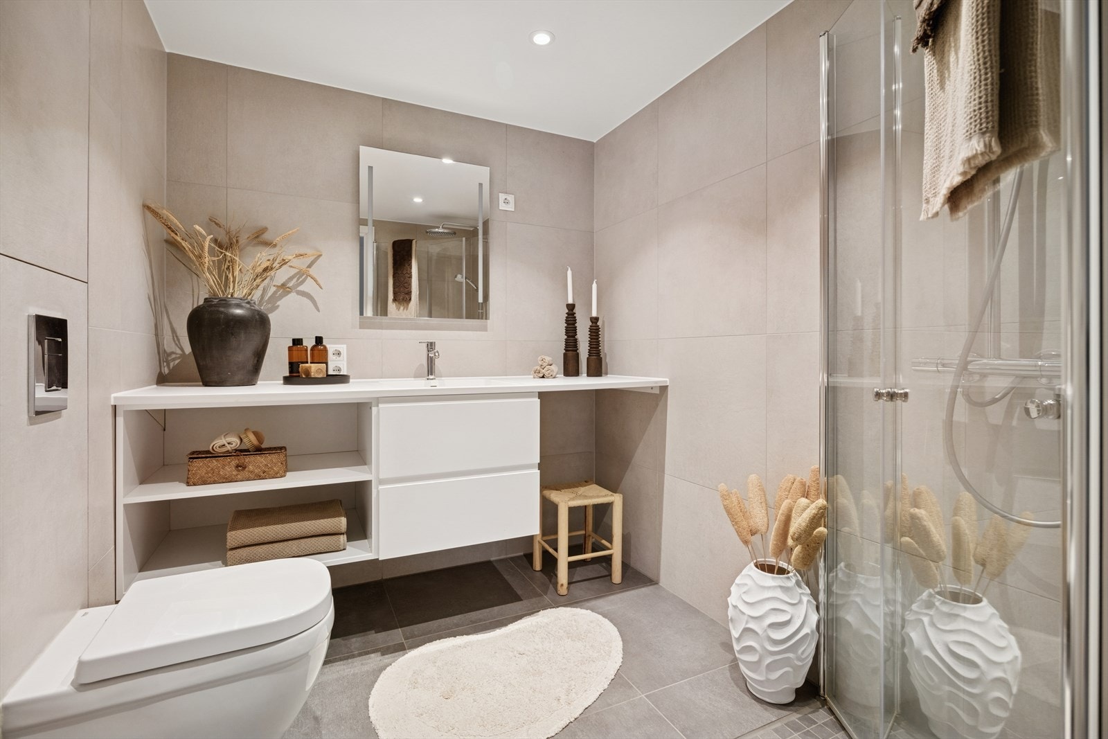 Delikat baderom med vannbåren gulvvarme og 60x60 fliser. Innfellbare dusjvegger, opplegg til vaskemaskin og vegghengt wc med flislagt innkassing. Galleribilde